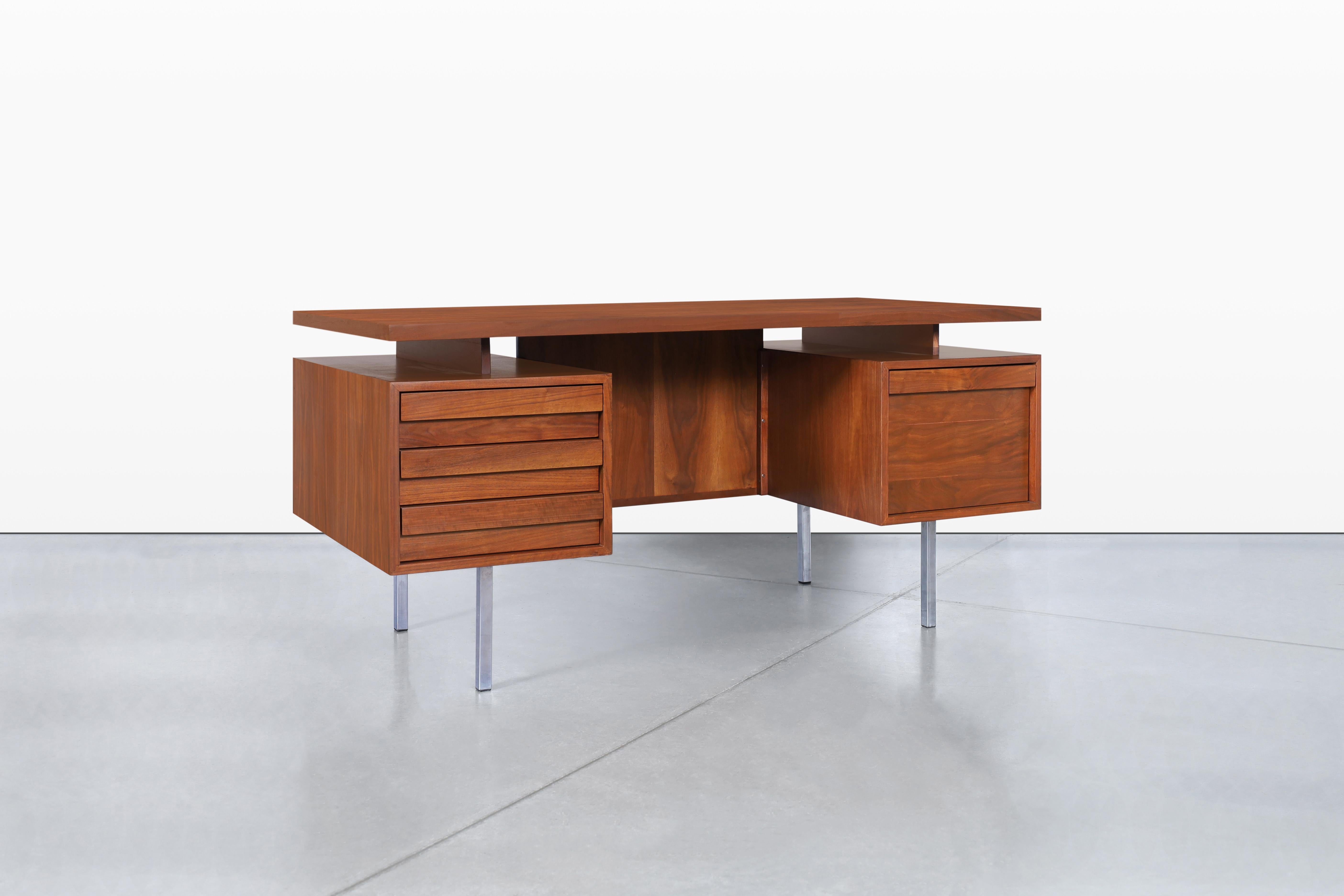 I'm excited to introduce you to this stunning mid-century executive desk, created by the renowned designer John Keal for Brown Saltman in the 1950s. This piece is not just furniture; it's a perfect blend of functionality and style that can elevate