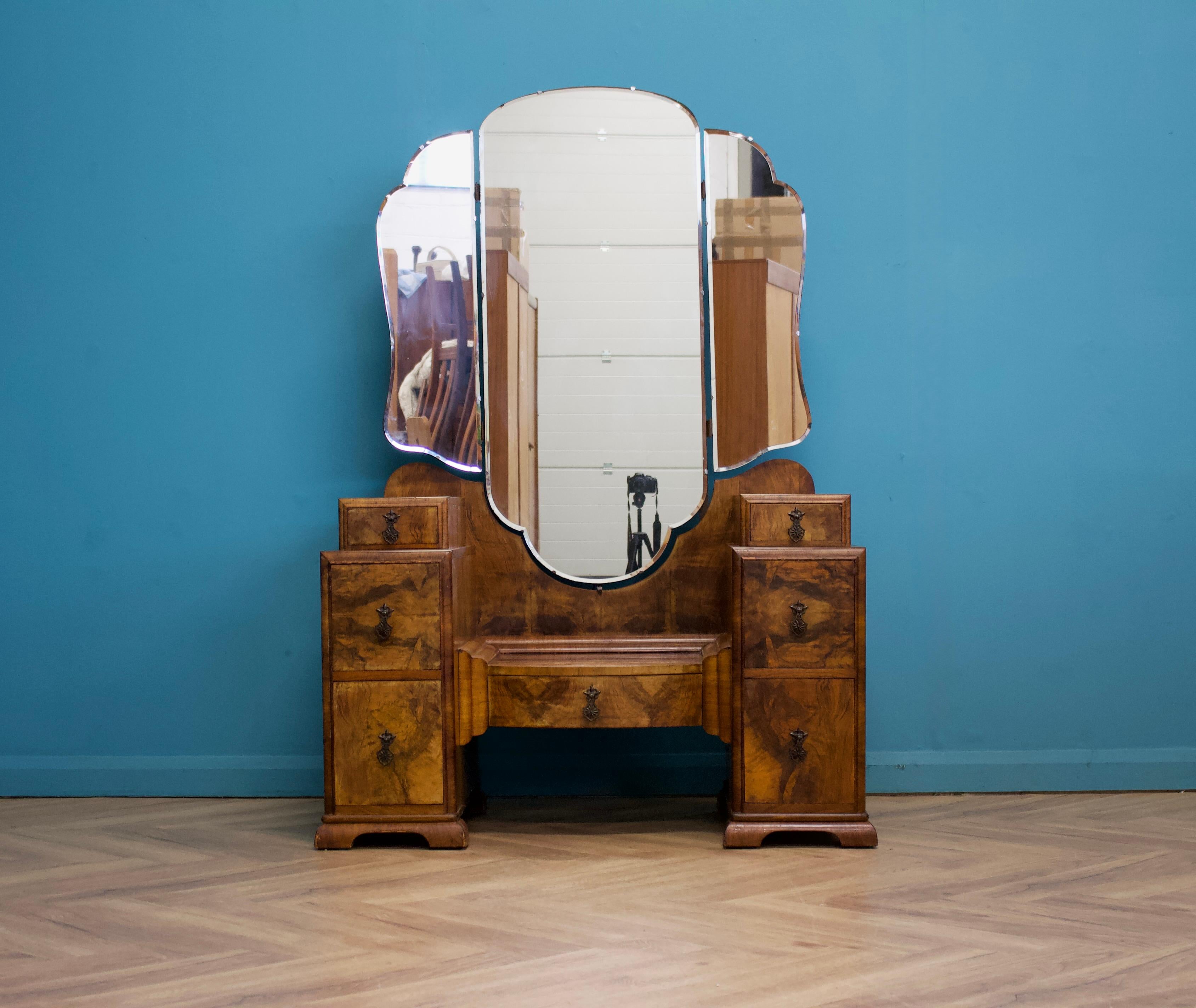 An Art Deco walnut dressing table - circa 1930's
Featuring a stunning large triptych mirror to the middle
There are seven drawers in total

Height to the top of the mirror is 167cm

The tallboy is listed for sale separately