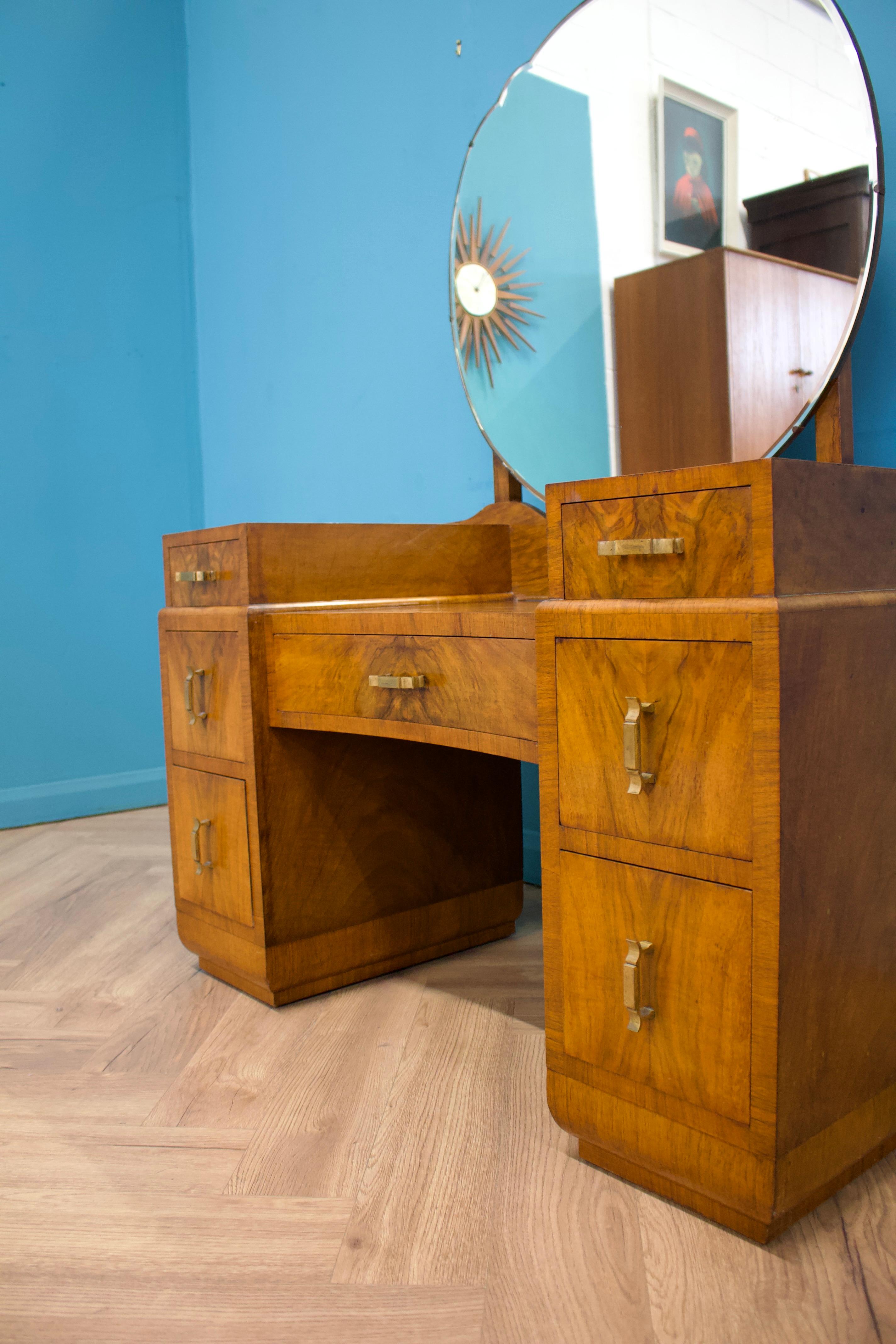 An Art Deco walnut dressing table - circa 1930's
Featuring a mirror to the middle
There are five drawers in total

Height to the top of the mirror is 142cm

The matching compactum wardrobe is listed for sale separately