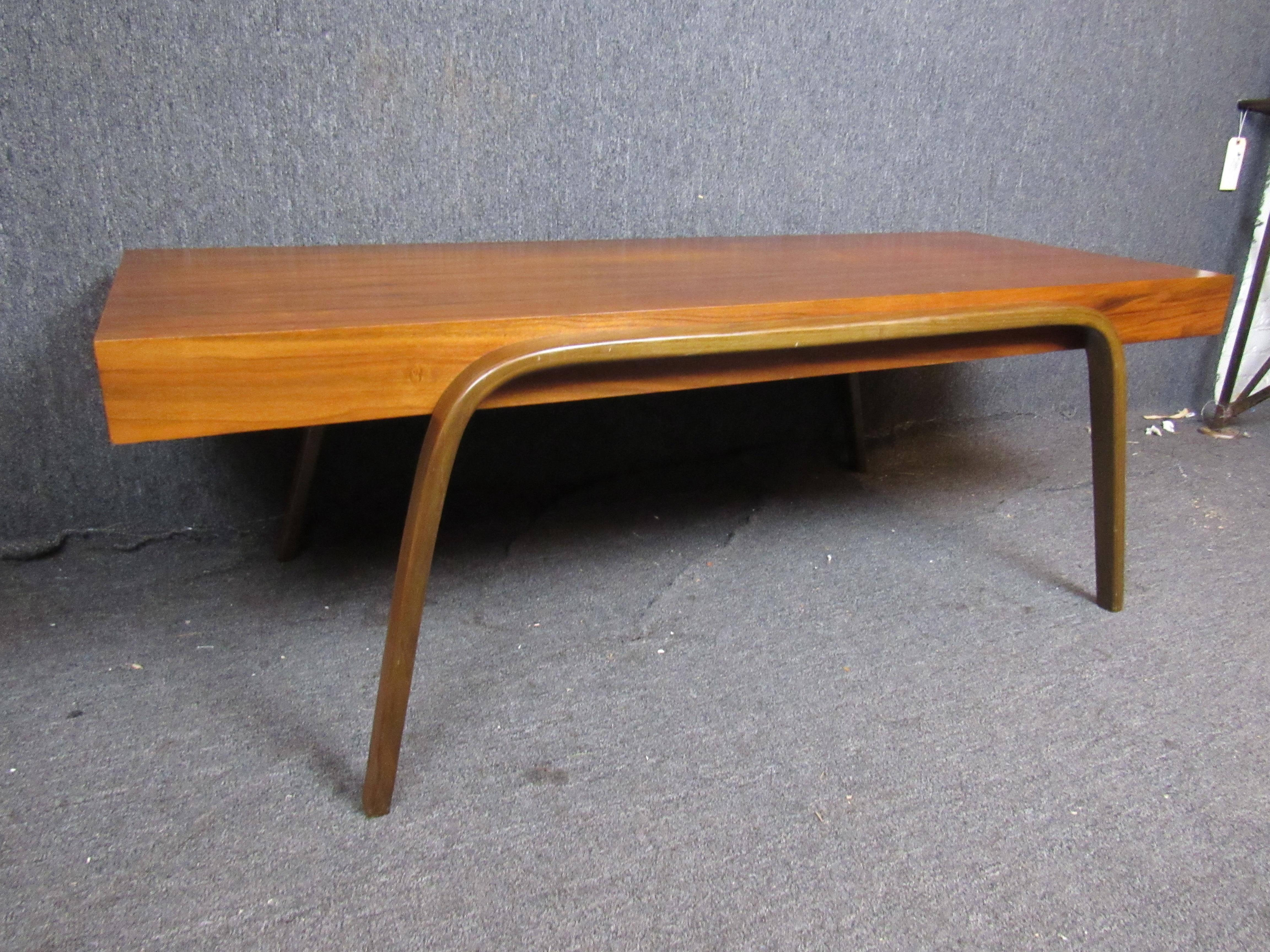 Wonderful walnut coffee table with unique bentwood legs! Authentic mid-century modern design provides timeless functionality and aesthetics. 
Please confirm item pickup location (New York or New Jersey) with dealer.