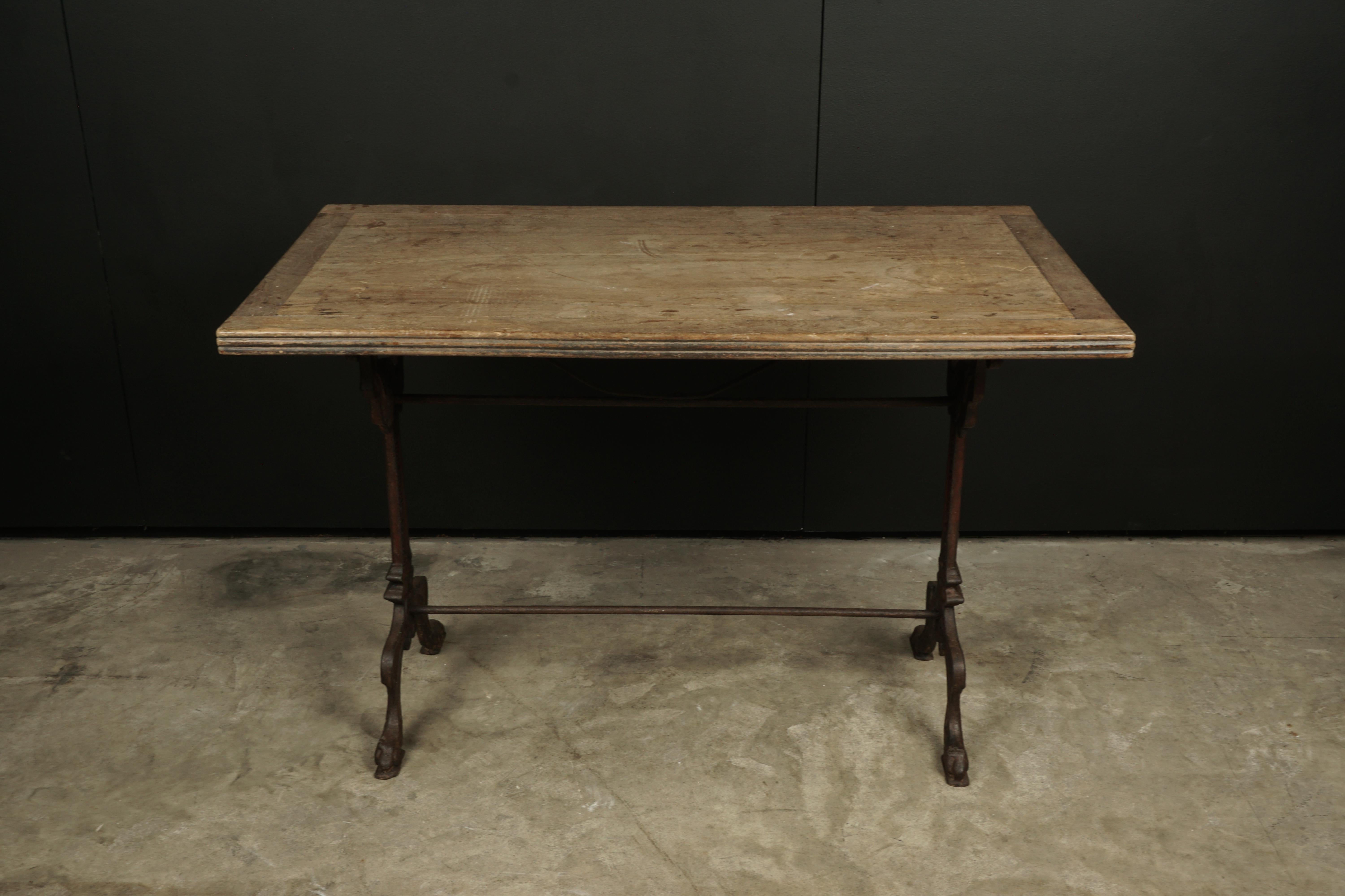 Vintage walnut Bistro table from France, 1950s. Solid walnut top with an iron base. Fantastic wear and patina.