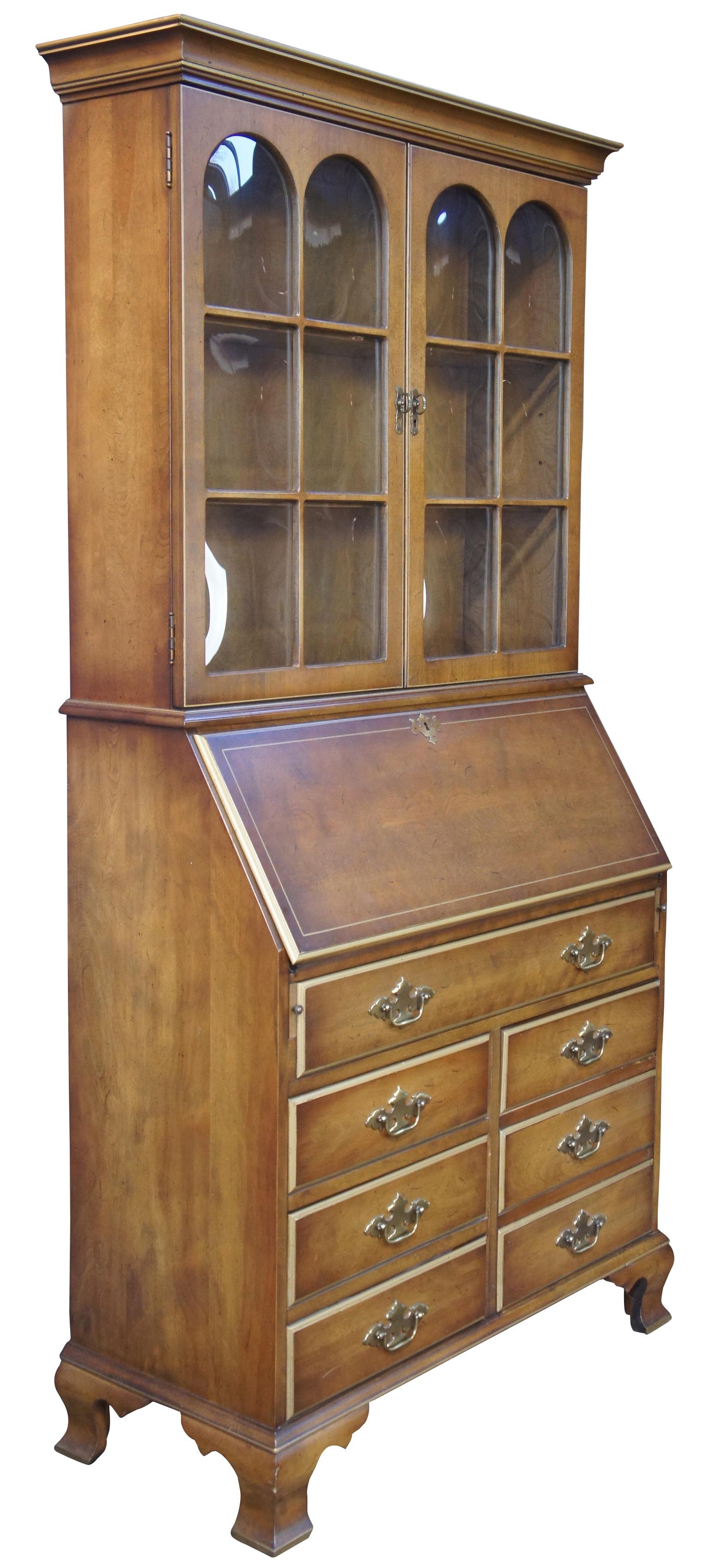 Vintage library secretary desk with bubble glass bookcase, circa 1970s/1980s. Inspired by a blend of Georgian and Federal Styling. Made of walnut featuring five drawers including one large file storage and a drop front secretary that opens to more