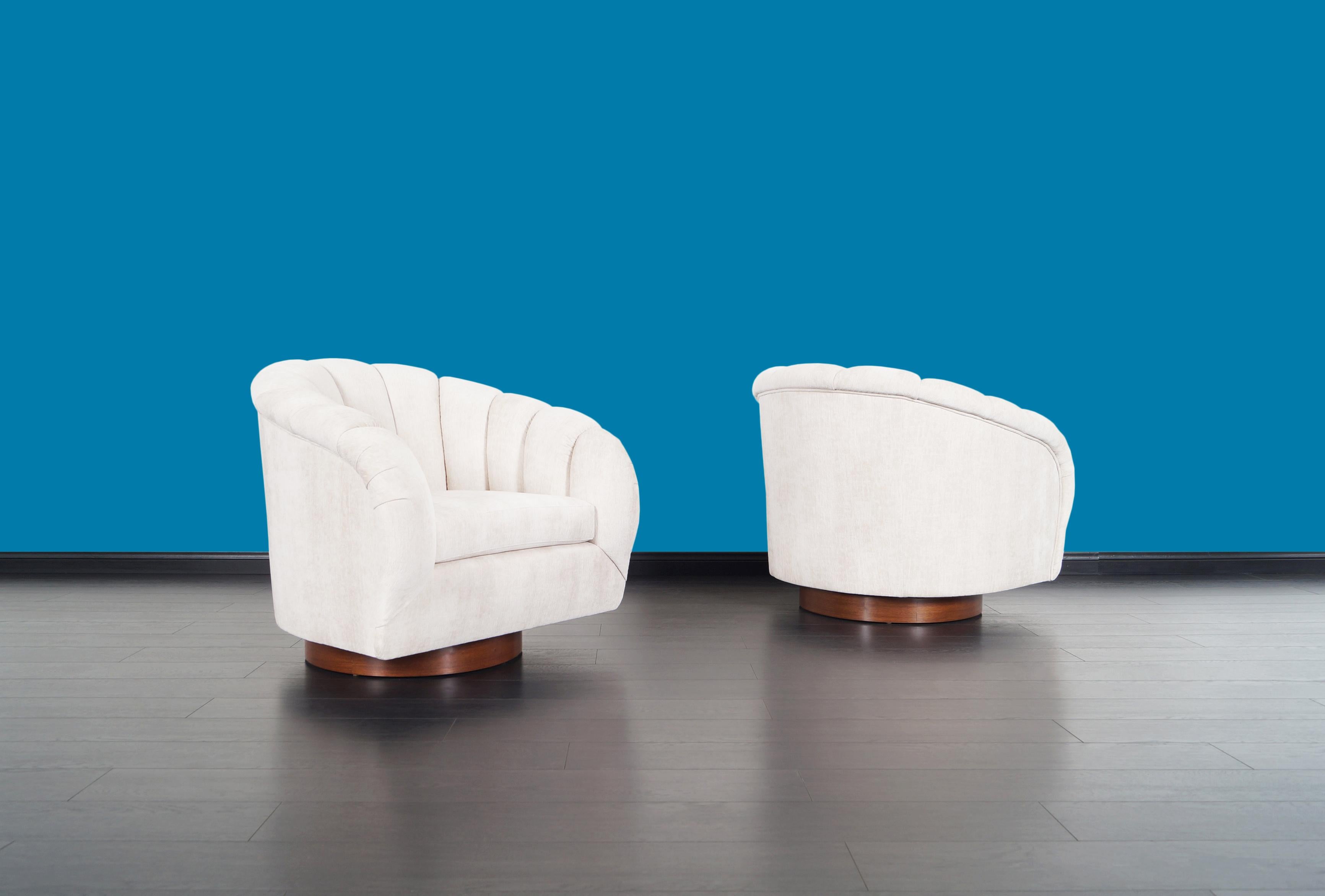 American Vintage Walnut Channel Back Swivel Lounge Chairs in the style of Milo Baughman