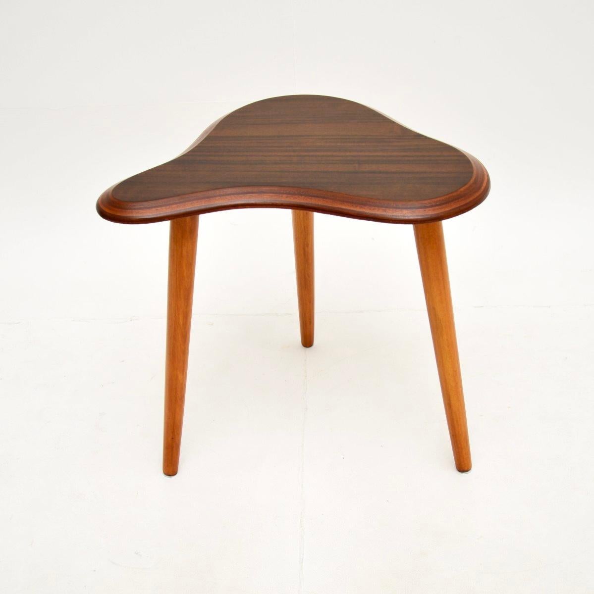 A stunning and extremely rare vintage walnut cloud side table by Neil Morris. It was made by Morris of Glasgow in Scotland, it dates from the 1950’s.

This model is exceedingly rare, we have never come across it before. As with the slightly larger