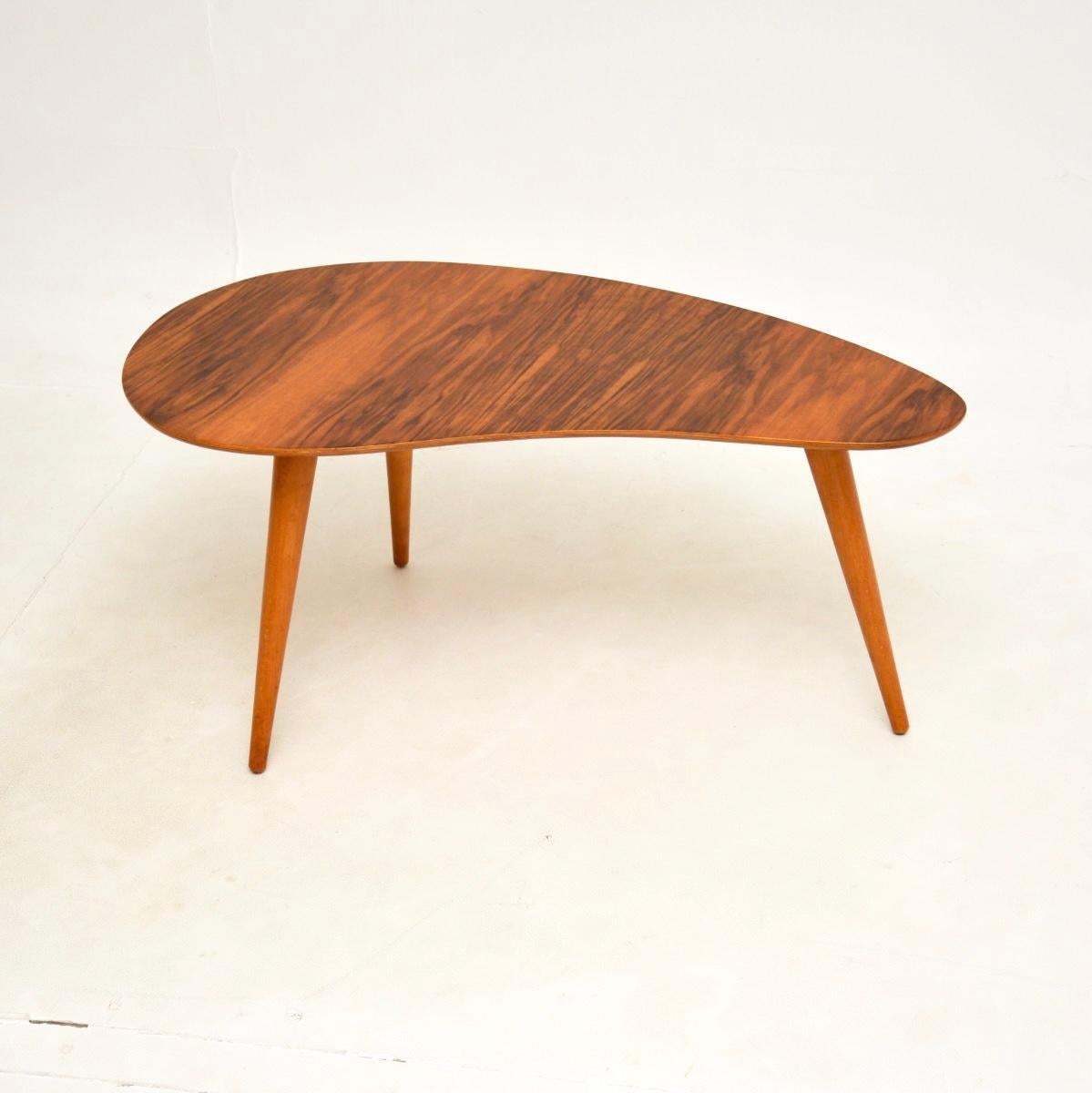 A stunning vintage walnut coffee / side table, made in England and dating from the 1950’s.

It has a stylish palette shaped design, with absolutely gorgeous walnut grain patterns and colour tones. It is a great size to be used as a coffee table or