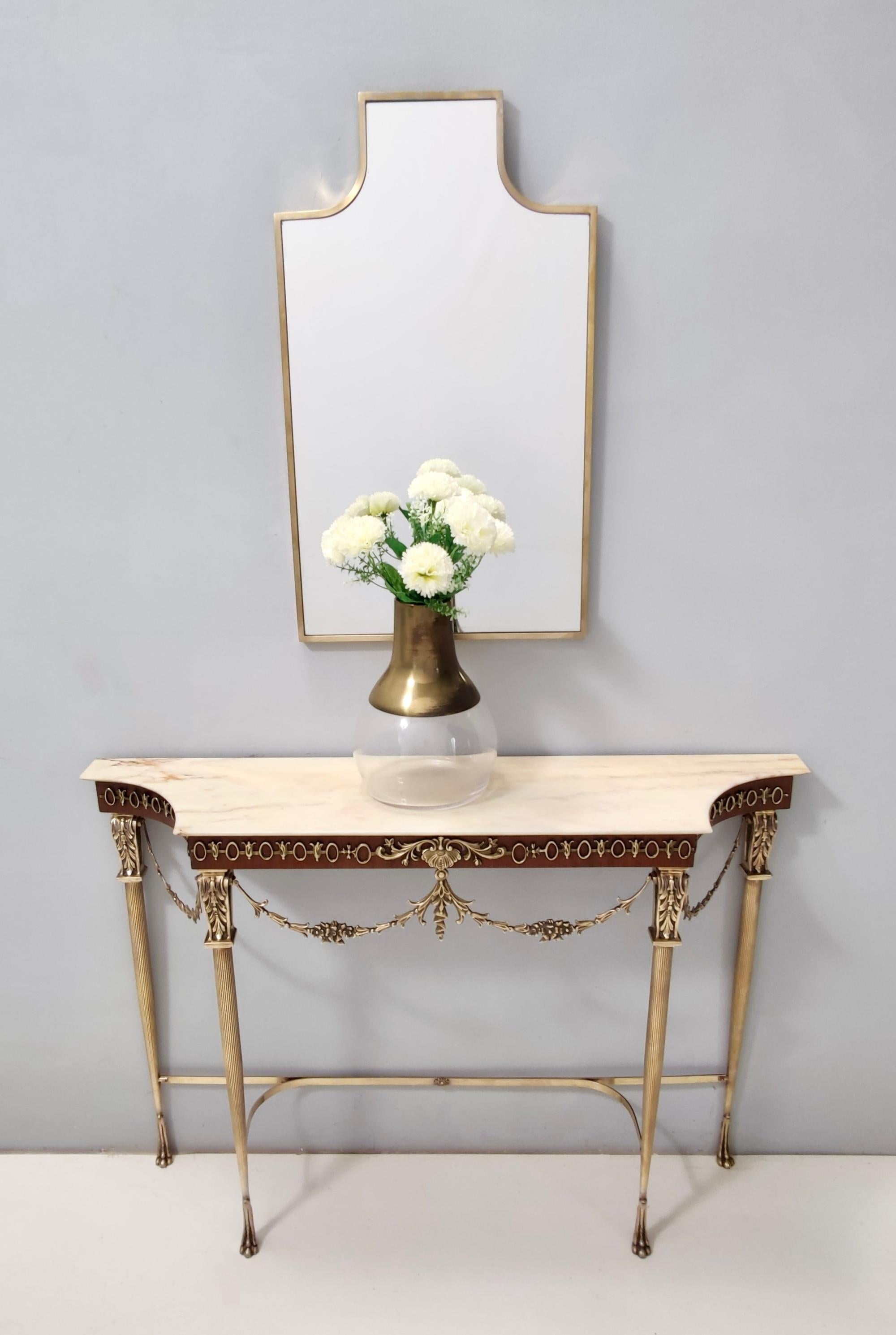 Made in Italy, 1950s.
This console table features a Portuguese pink marble top and a brass and walnut frame. 
It is a vintage item, therefore it might show slight traces of use, but it can be considered as in excellent original condition and ready