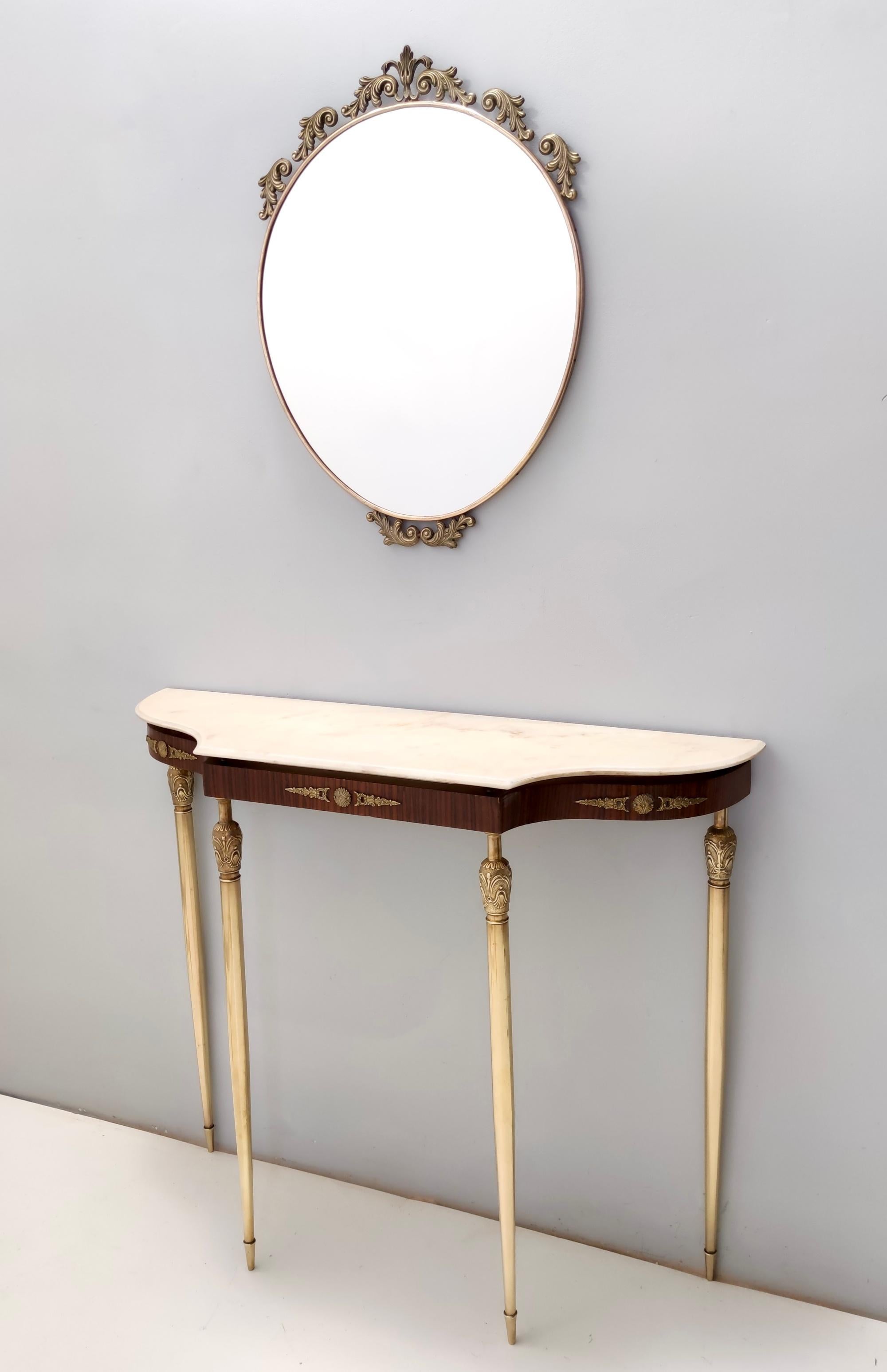 Made in Italy, 1960s.
This console table features a Portuguese pink marble top and a brass and walnut frame. 
It is a vintage item, therefore it might show slight traces of use, but it can be considered as in excellent original condition and ready