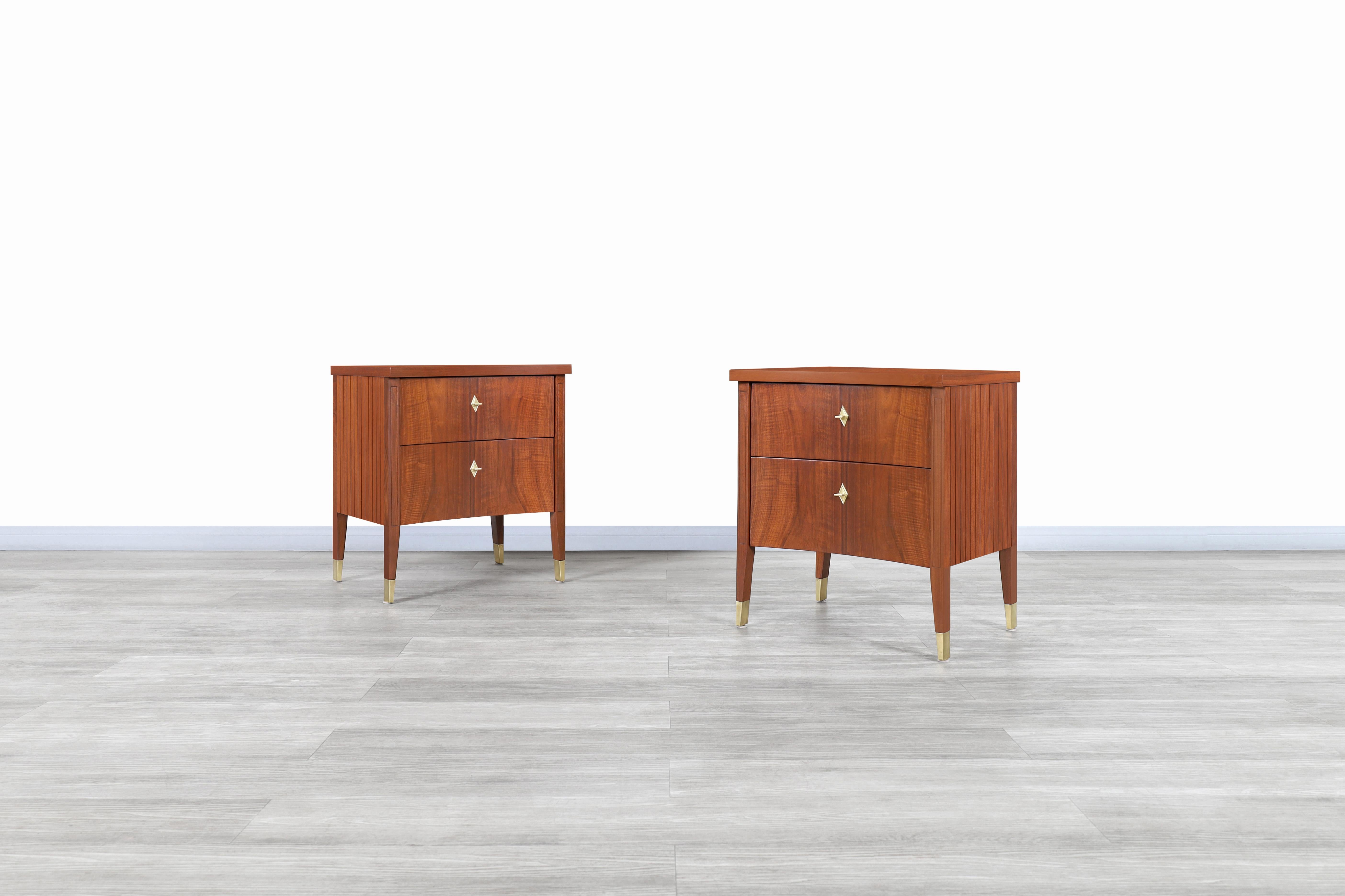 Stunning vintage walnut curved nightstands designed and manufactured in the United States, circa 1950s. These nightstands feature a curved design throughout their structure, allowing them to stand out from the rest while offering a unique view from