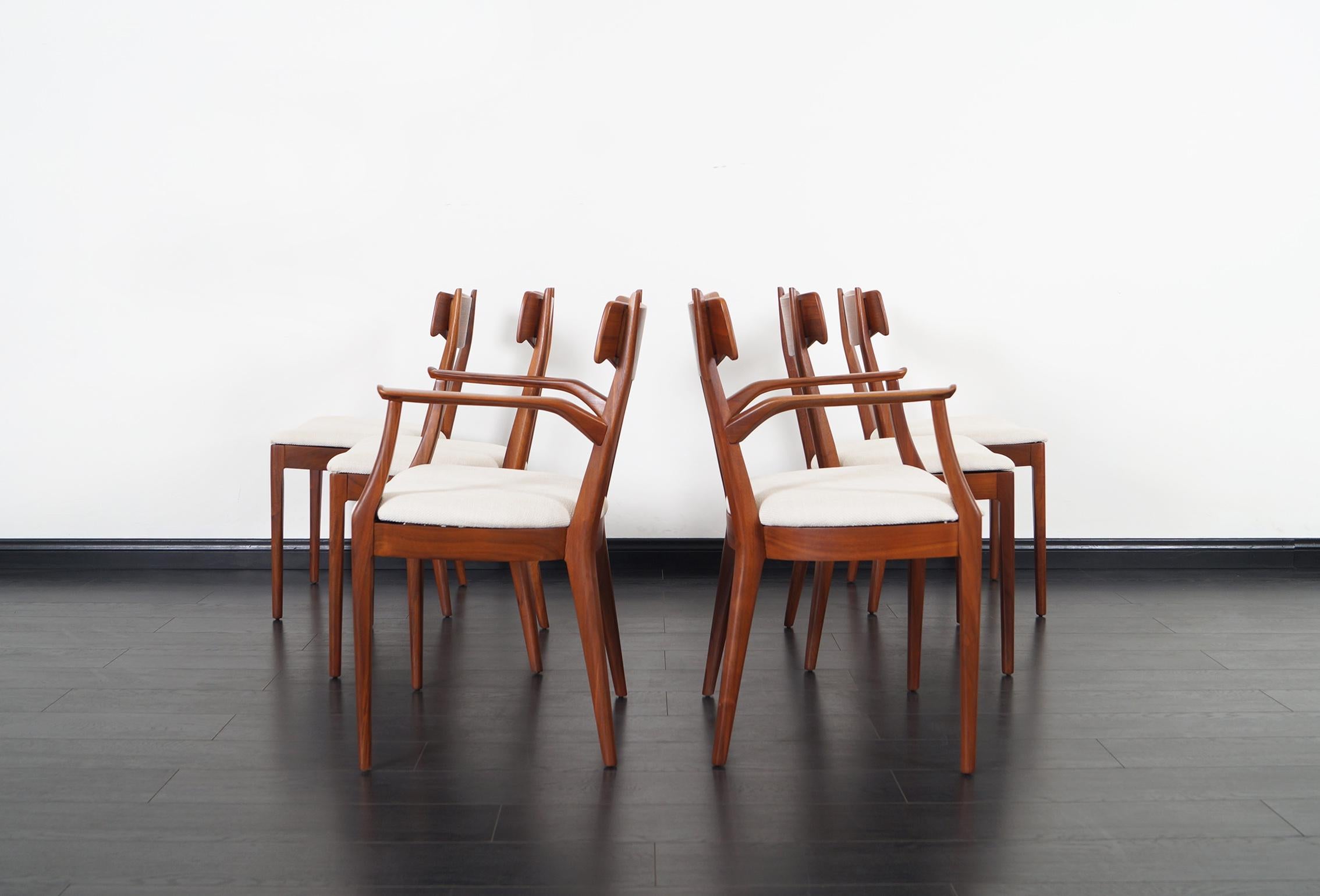 Vintage walnut dining chairs designed by Kipp Stewart & Stewart McDougall for Drexel Furniture. The chairs are made of solid walnut with rosewood inlay details and all the seats are newly reupholstered. Dimensions without armrest: 19.5