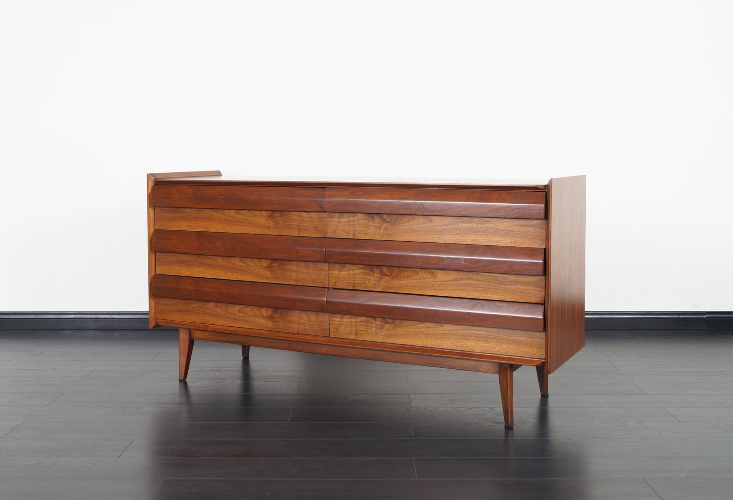 Modernist walnut dresser by Lane Furniture. Features six dovetail drawers with sculptural handles.