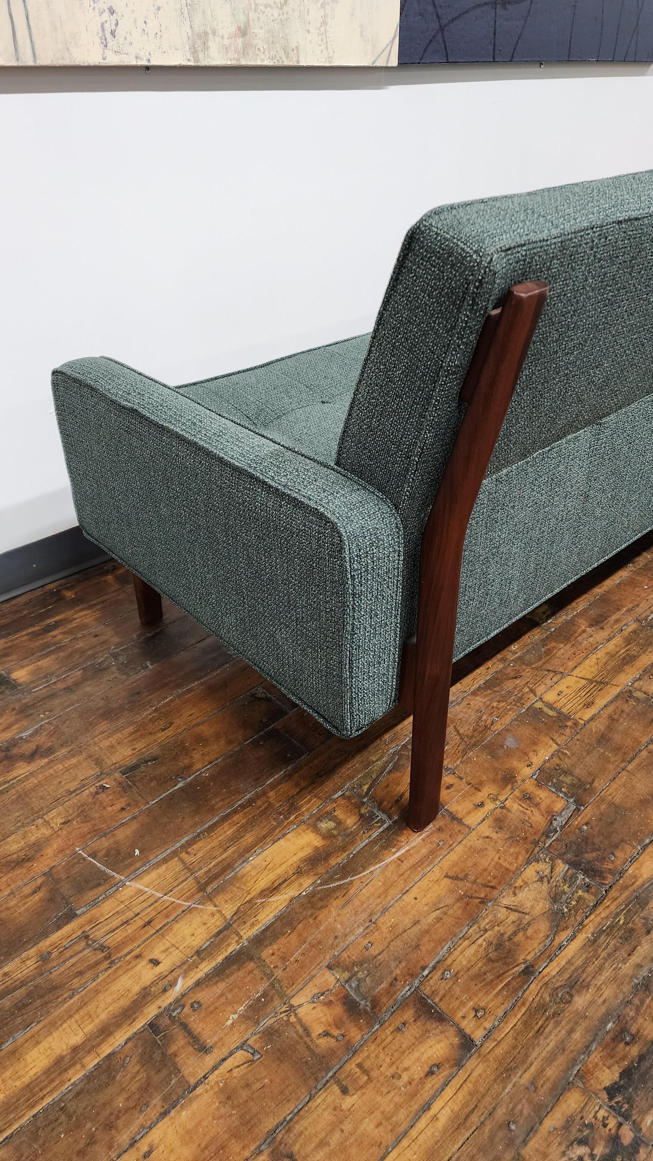 Vintage Walnut Frame Sofa by Jens Risom Designs. newly reupholstered with Maharam fabric. The exposed walnut back leg frame adds a beautiful accent against the green fabric. this classic design will look great in any style living space