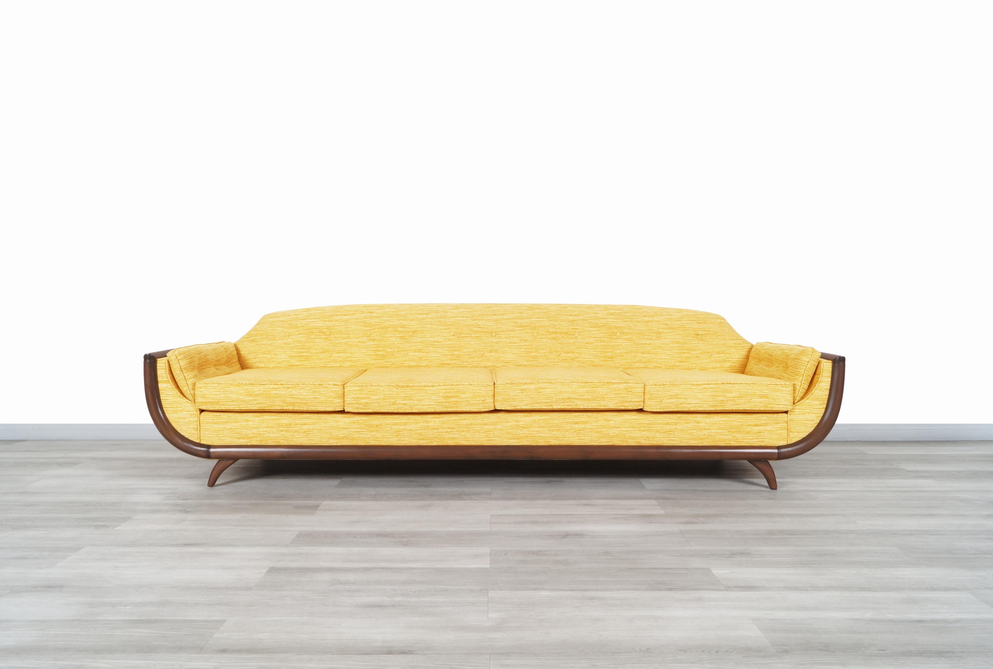 Beautiful vintage walnut “Gondola” sofa designed in the manner of Adrian Pearsall in the United States, circa 1960s. This modernist sofa has a captivating design and represents in a significant way the designs of Adrian Pearsall through the curve