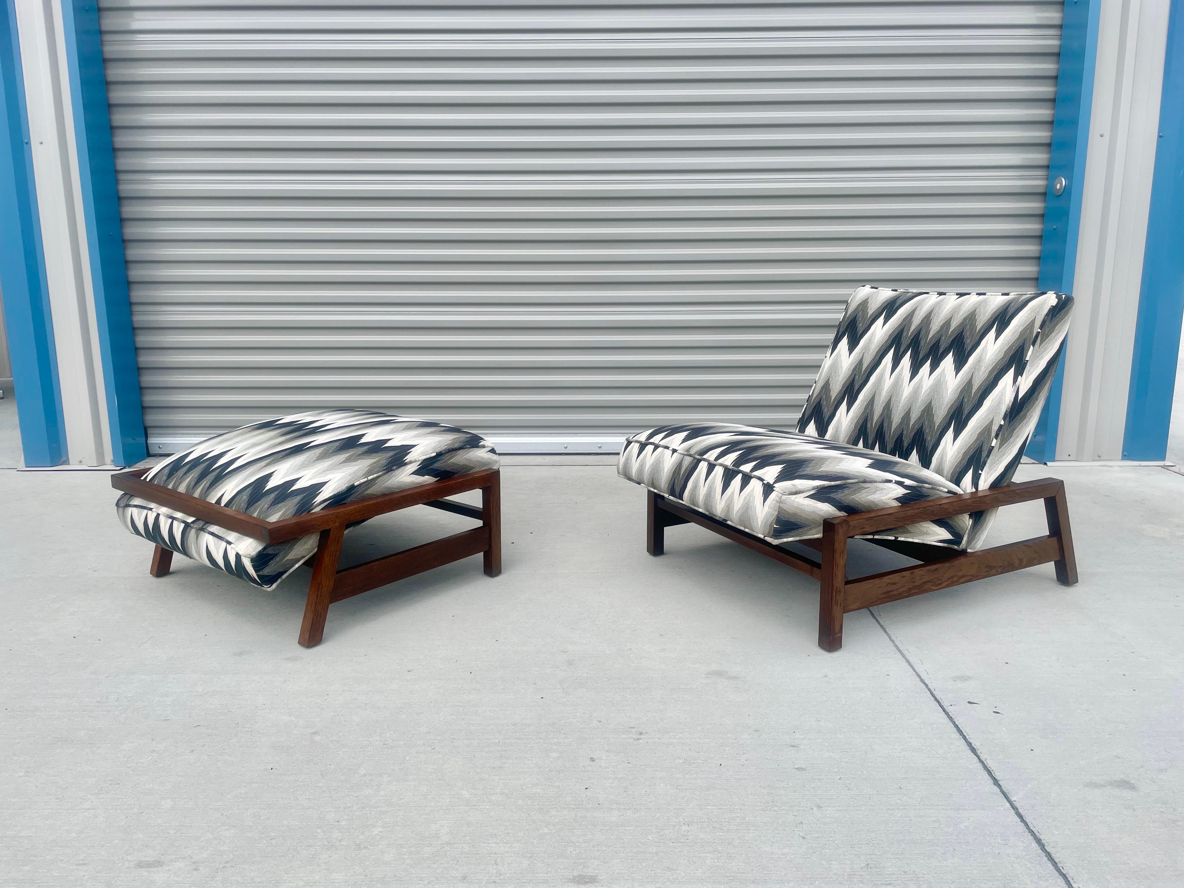 Vintage walnut lounge chair and ottoman in the style of Tobia Scarpa. This beautiful vintage chair and ottoman come with a unique rectangles walnut frame with a white and black upholstery pattern. The fabric is in good shape since it was previously