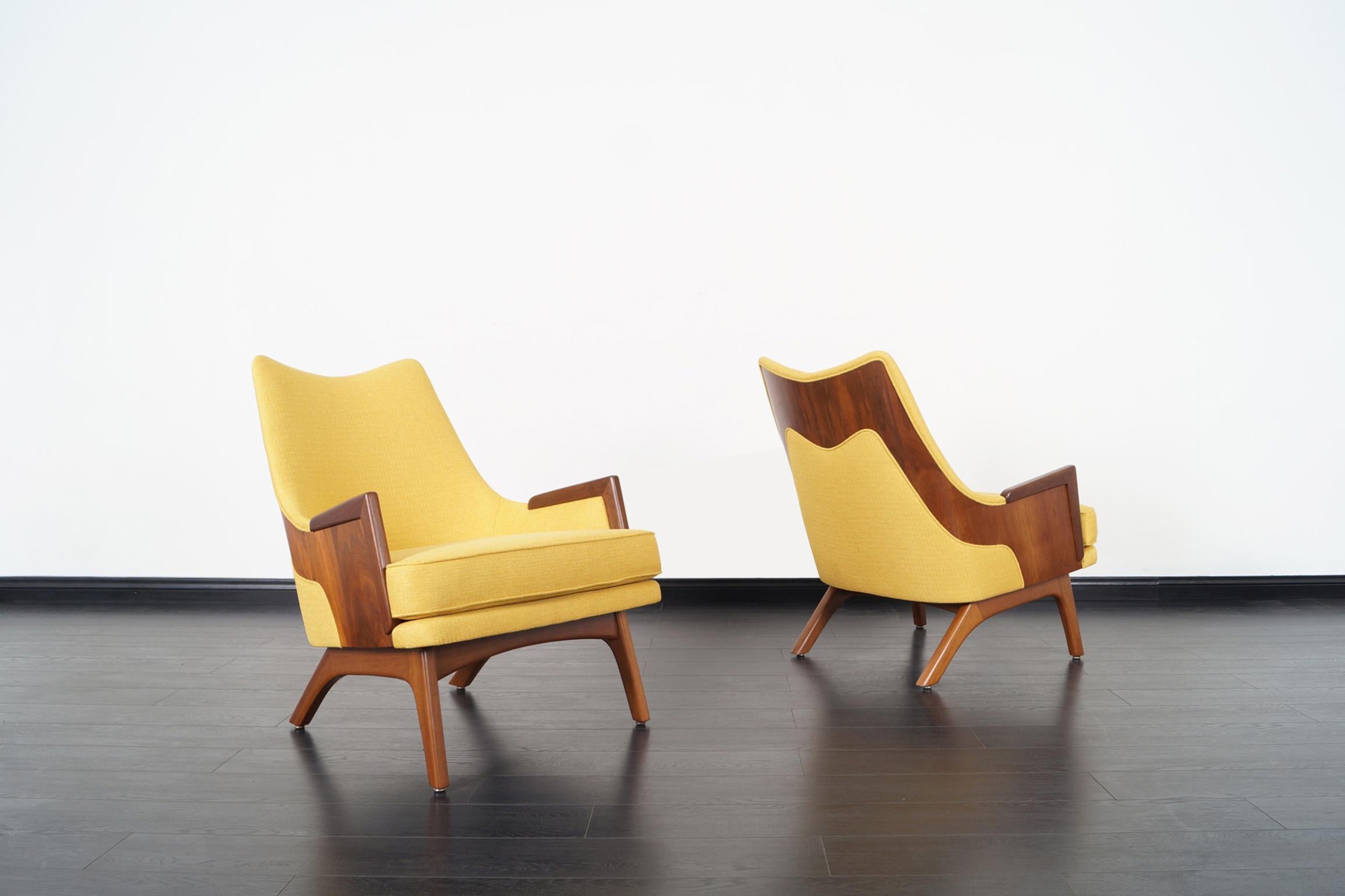 These exceptional rare walnut lounge chairs were designed by Adrian Pearsall for Craft Associates. These phenomenal chairs are simply amazing! Features a distinctive wrapped detail, where the walnut frame is exposed in a sculpted band across the
