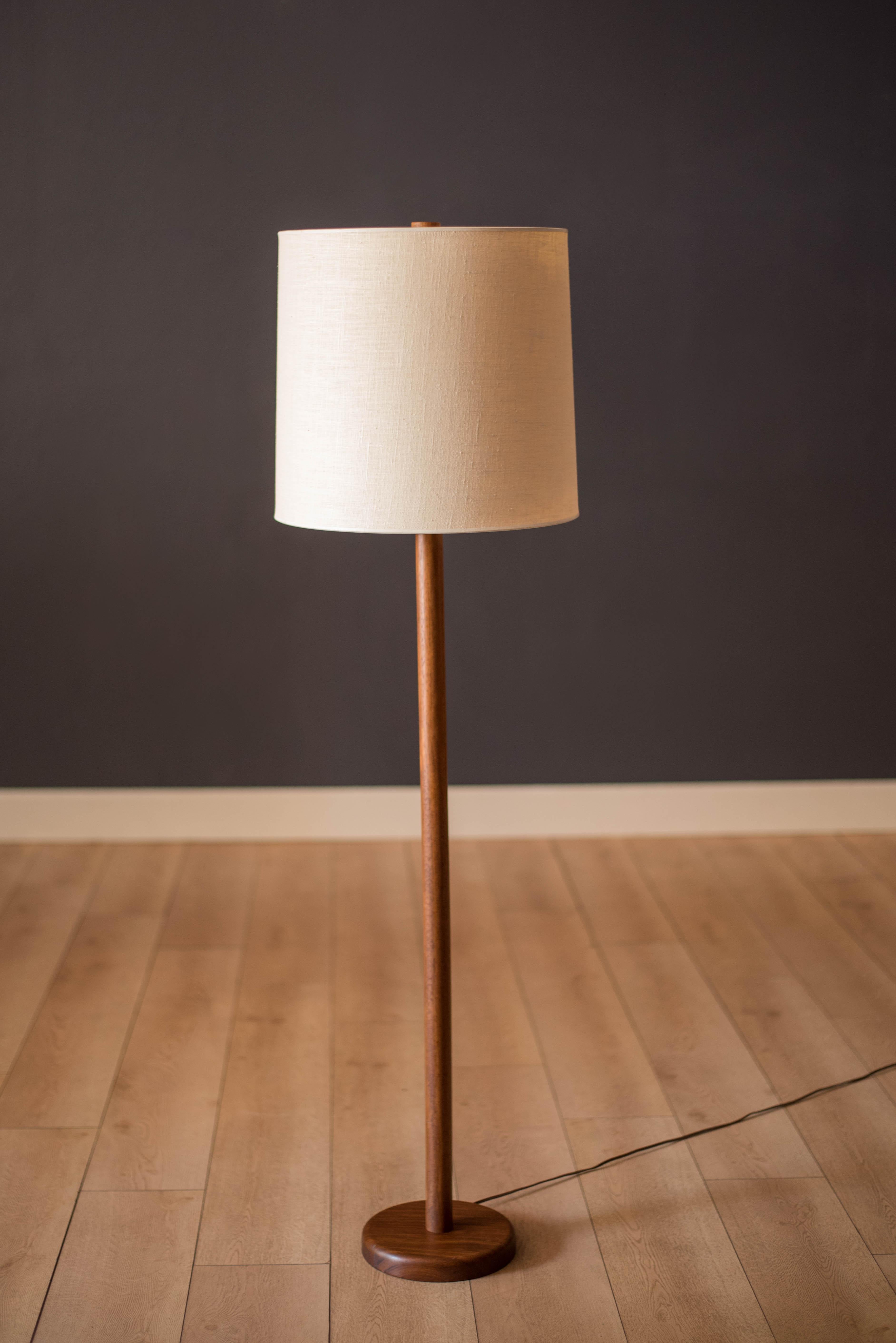 Mid-Century Modern floor lamp base in walnut designed by Jane and Gordon Martz for Marshall Studios circa 1960s. This Classic design features a three-way switch mechanism and walnut wood finial. The lamp shade is not included.