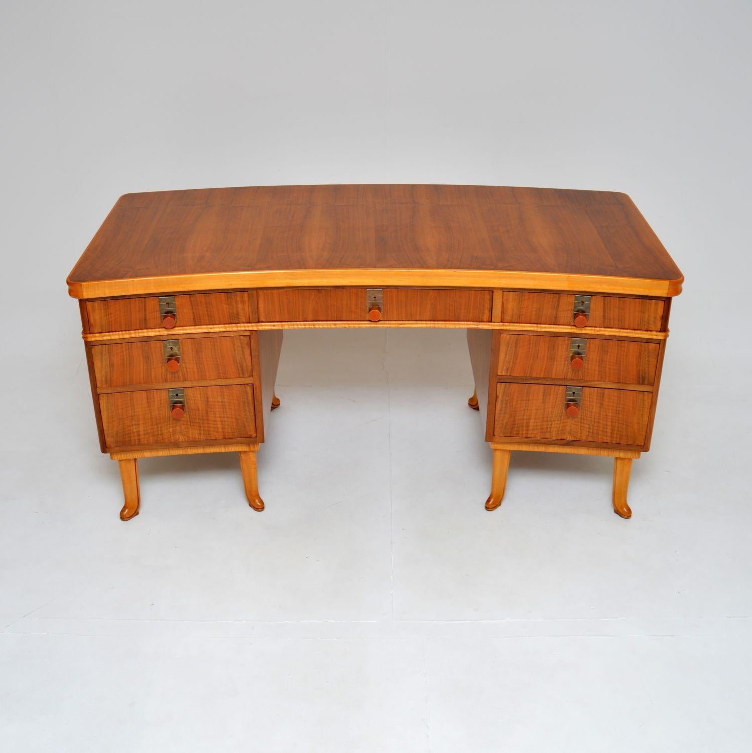 A spectacular vintage walnut pedestal desk by Laszlo Hoenig. This was made in London, there is a label beneath the top with the production year of 1951.

It is of outstanding quality, this is extremely well made and it has a gorgeous design. The top