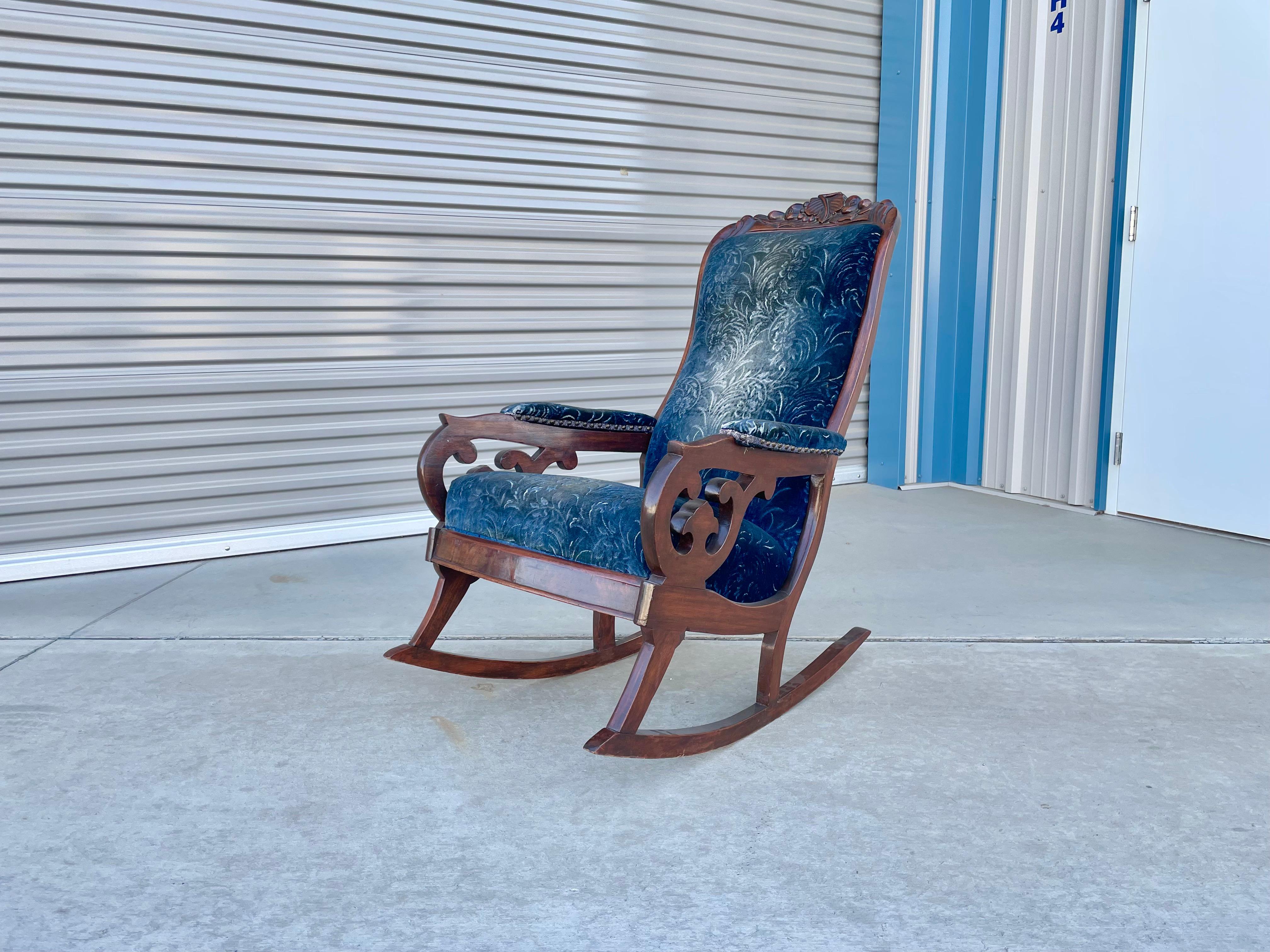 Vintage walnut rocking chair designed and manufactured by Biedermeier in Germany, circa 1940s. This beautiful rocker features a high back backrest that provides comfort and style. The chair also features a unique sculpture design on the walnut