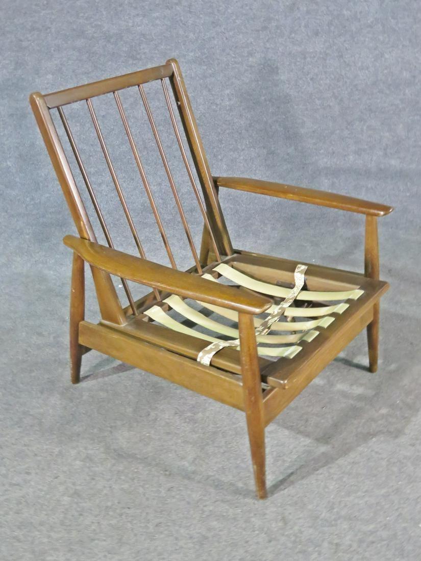 With rich walnut making up this chair's frame and spindle back, this vintage rocking chair is full of Mid-Century style. Please confirm item location with seller (NY/NJ).