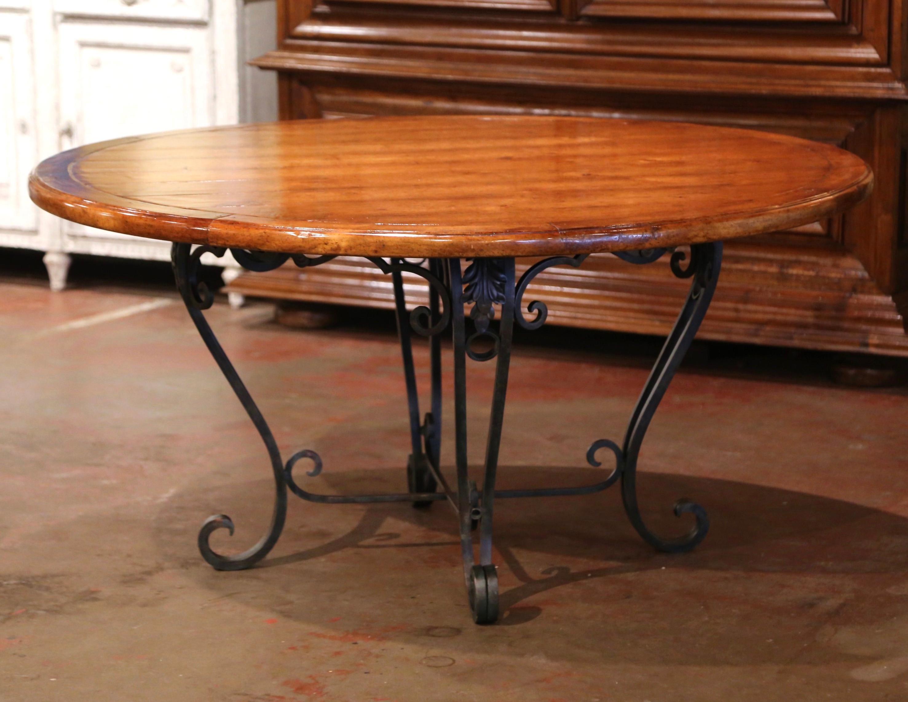 round wood dining table with wrought iron base