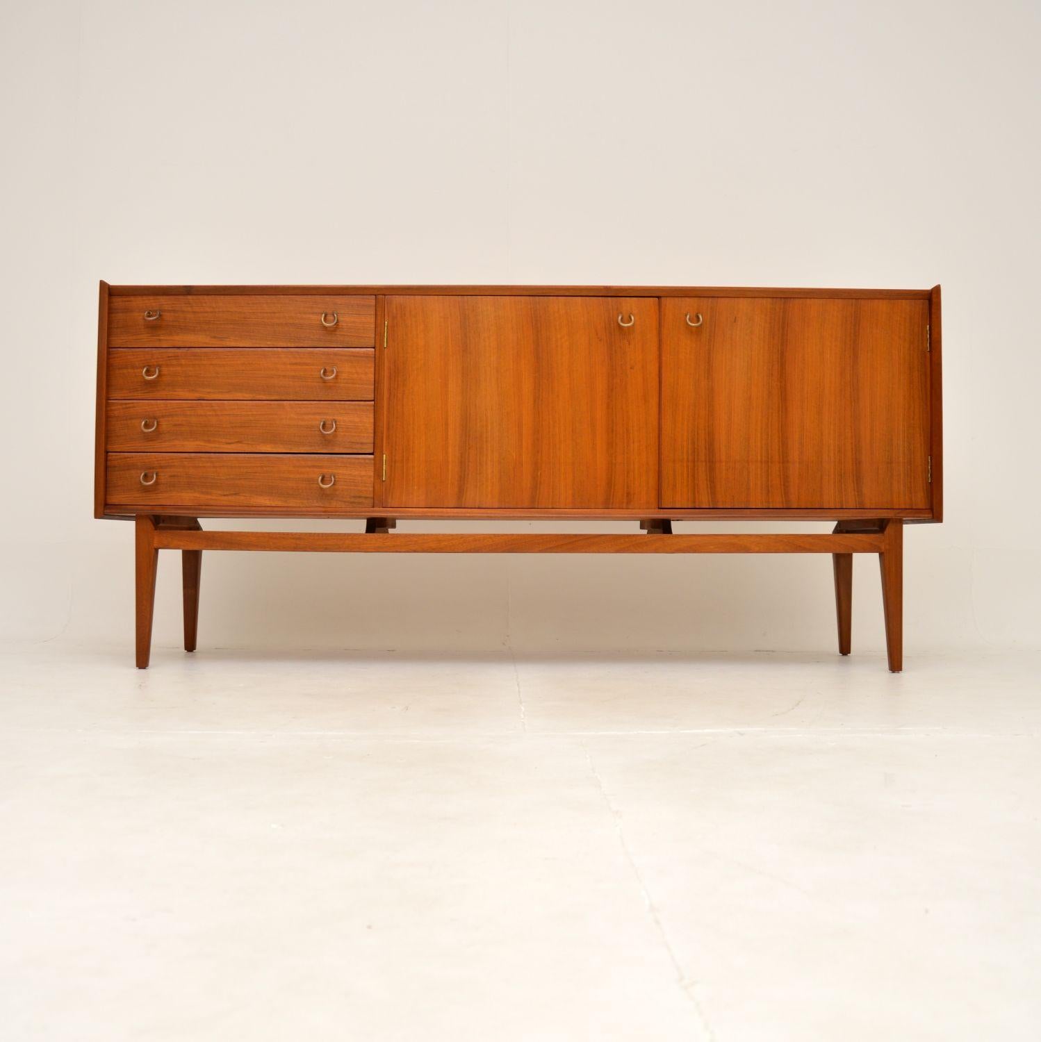A very stylish and extremely well made vintage walnut sideboard by John Herbert for Younger. This was made in England, it dates from the 1950-60’s.

The quality is outstanding, this is beautifully designed and is a very useful size. It is low and