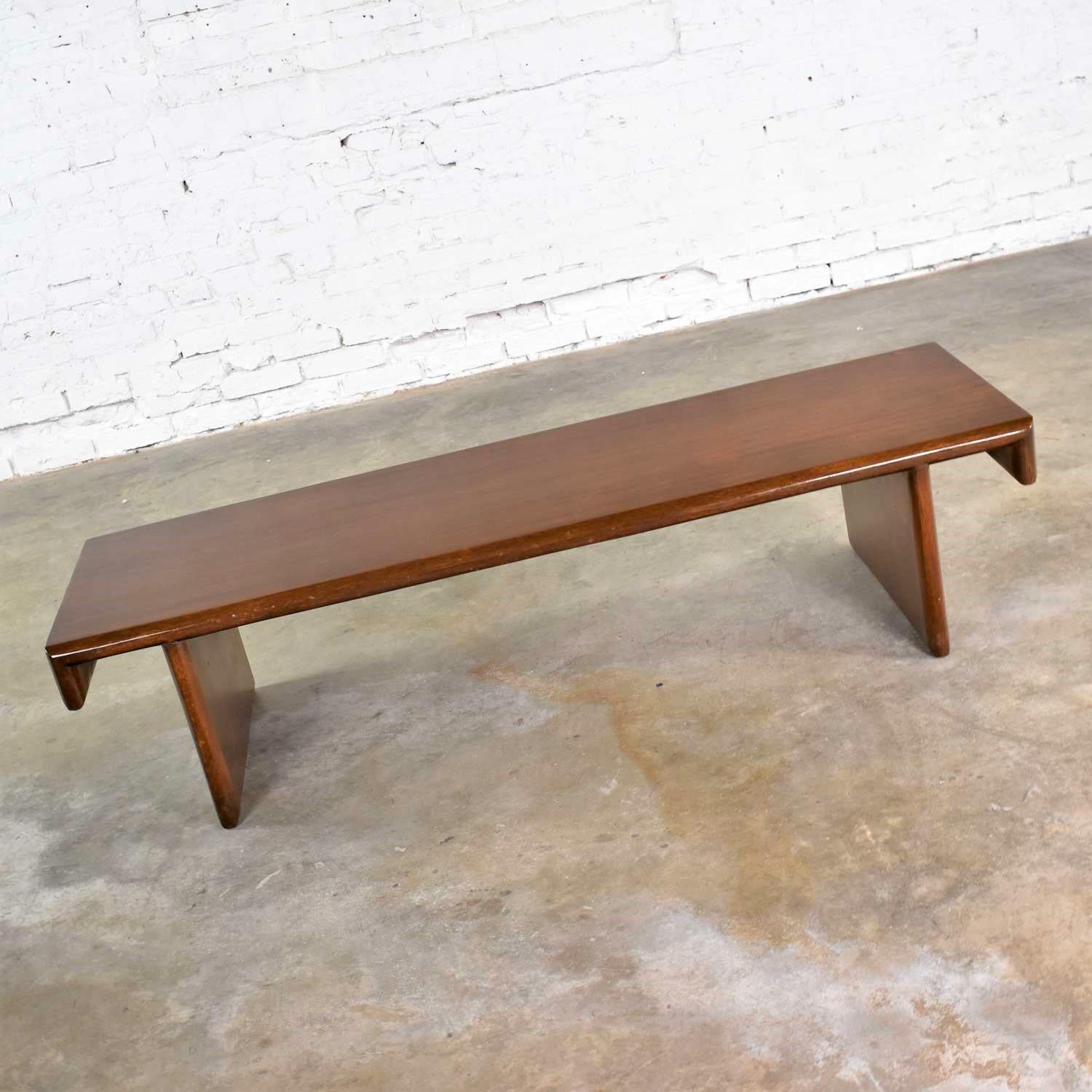 Handsome walnut stained mahogany bench or coffee table custom made in the style of Frank Lloyd Wright for Henredon. It is in wonderful original vintage condition. It does have some signs of age including small scratches and nicks and dings; but