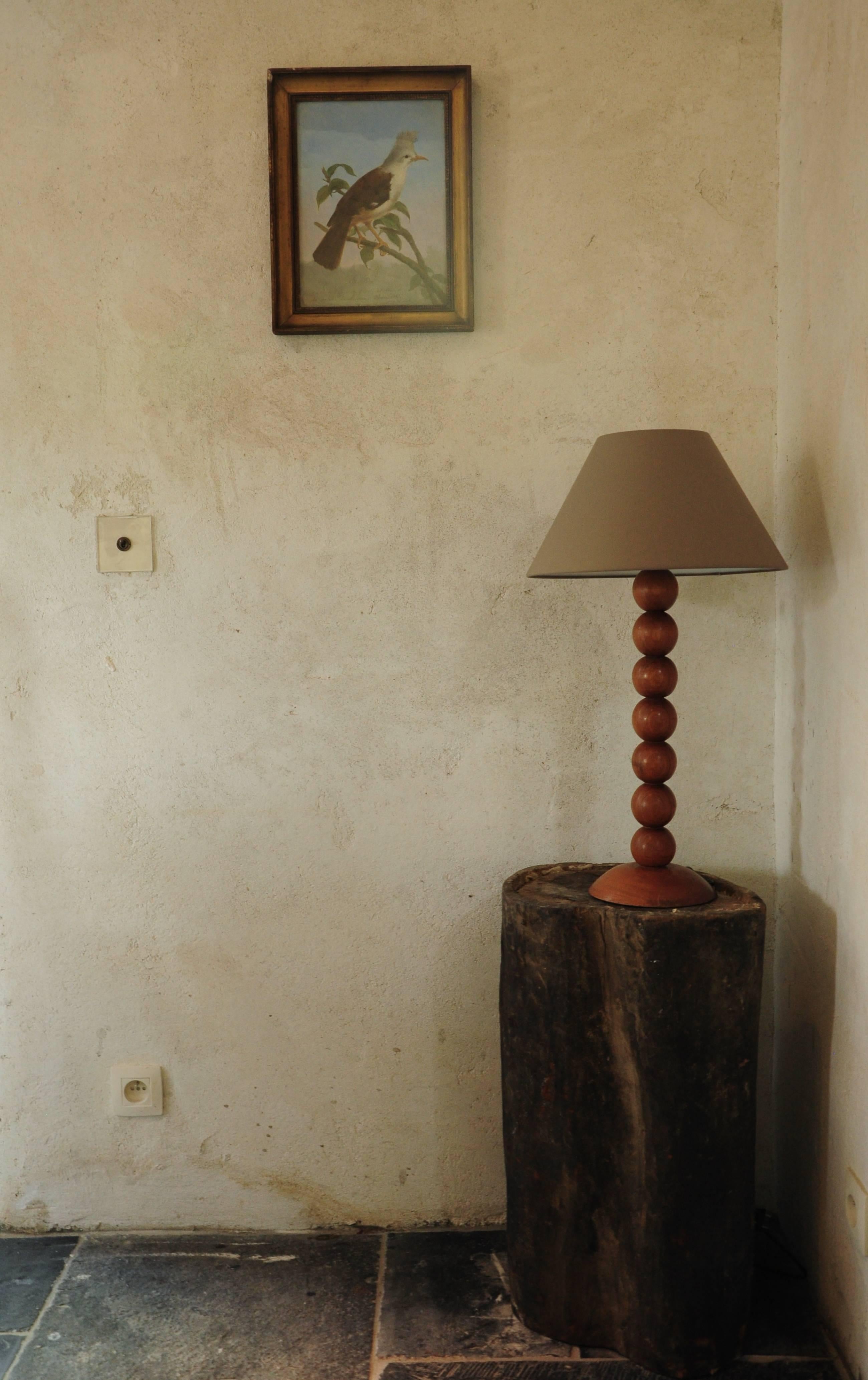 Beautifully turned walnut table lamp in a poppy, 1960s style. The creator of this lamp clearly was familiar with the quality of Classic woodturning and used this knowledge for a modern design. Its clean lines are accentuated by the warm rich color