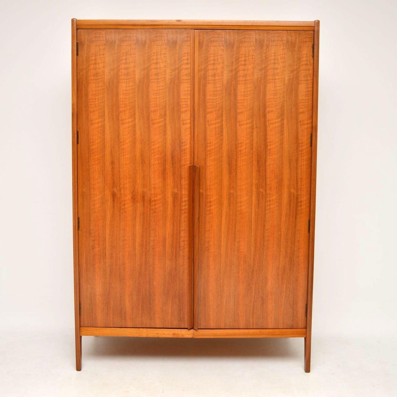 A beautifully made and very rare vintage wardrobe in walnut, this was made by Younger, it dates from the 1960s. It has a beautiful Minimalist design, with a gorgeous color and stunning walnut grain patterns. The condition is excellent for its age,