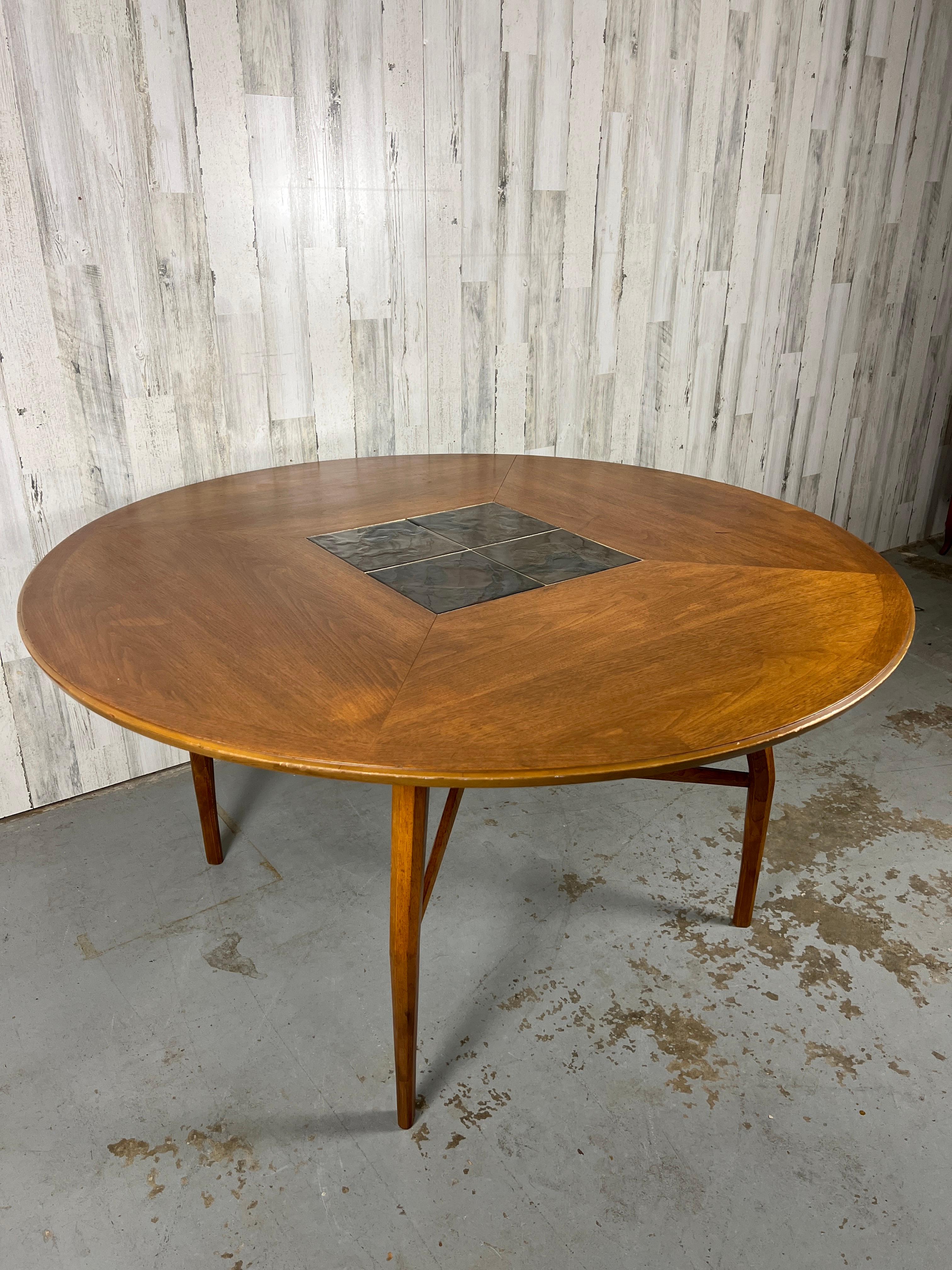 Spider leg style walnut table withe Roma tiles inlaid into the center. X base center stretcher that makes for a very sturdy surface. This table is in all original condition please see pictures. 