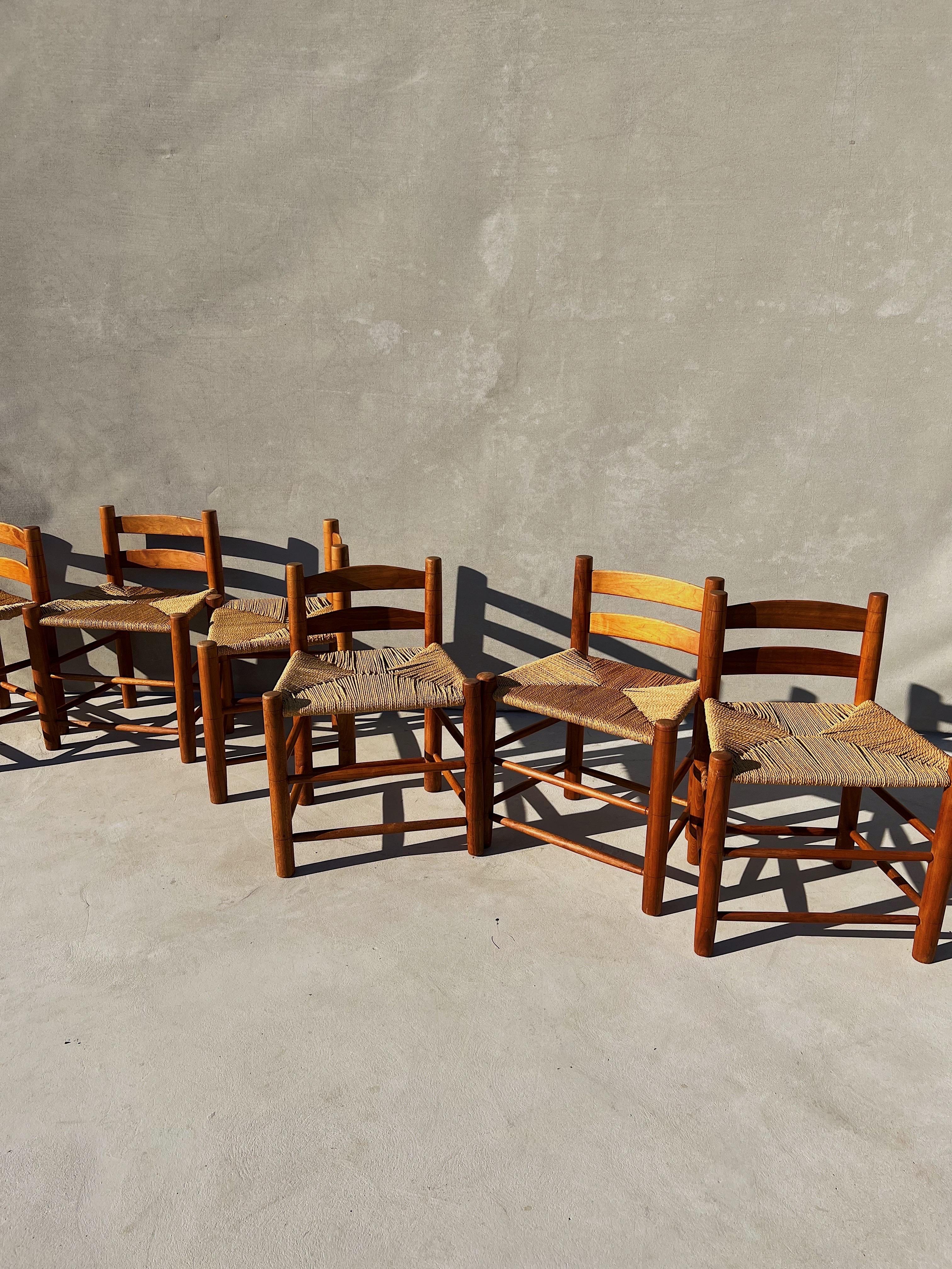 One of a kind dining chairs, custom made sometime in the mid-late 20th century

Each chair is sculpted out of a a warm, electric and dramatically veined walnut wood- tone and color similar to teak wood 

Thoughtful details - rope woven seats,