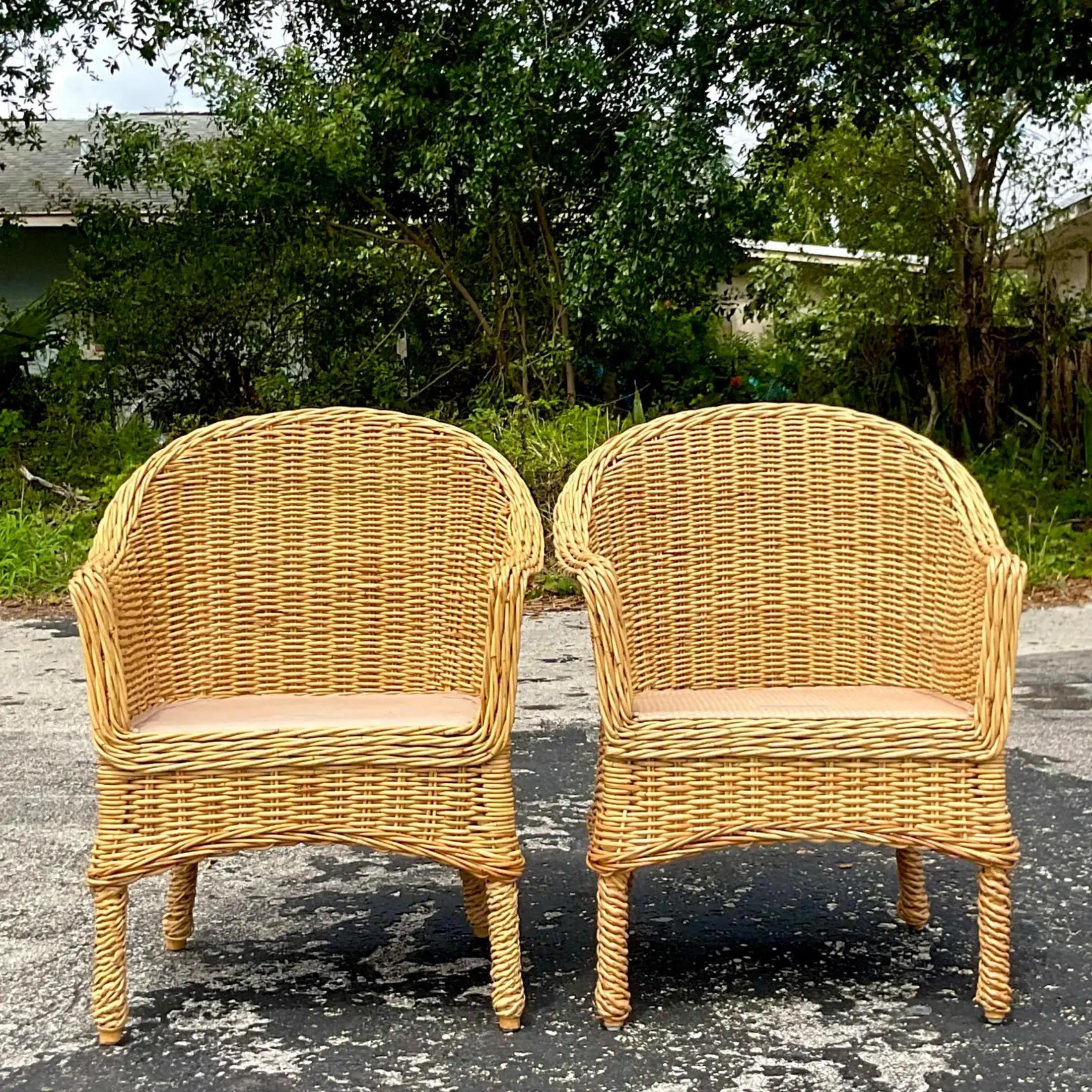 A vintage pair of chic coastal rattan lounge chairs. Made by the iconic Walters Wicker and tagged on the seat. Acquired at a Palm Beach estate