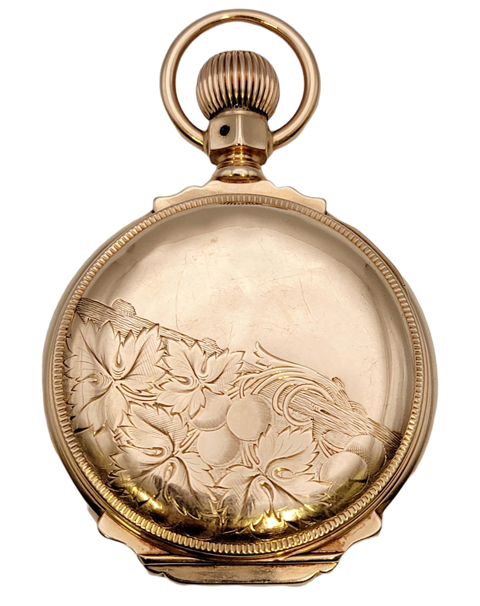 This rare vintage 14 karat gold pocket watch by Waltham is a stunning piece of history. The luxury solid gold timepiece is made with exquisite fine details. It features a 46mm case with a round white dial and black Roman Numeral hour markers. Also