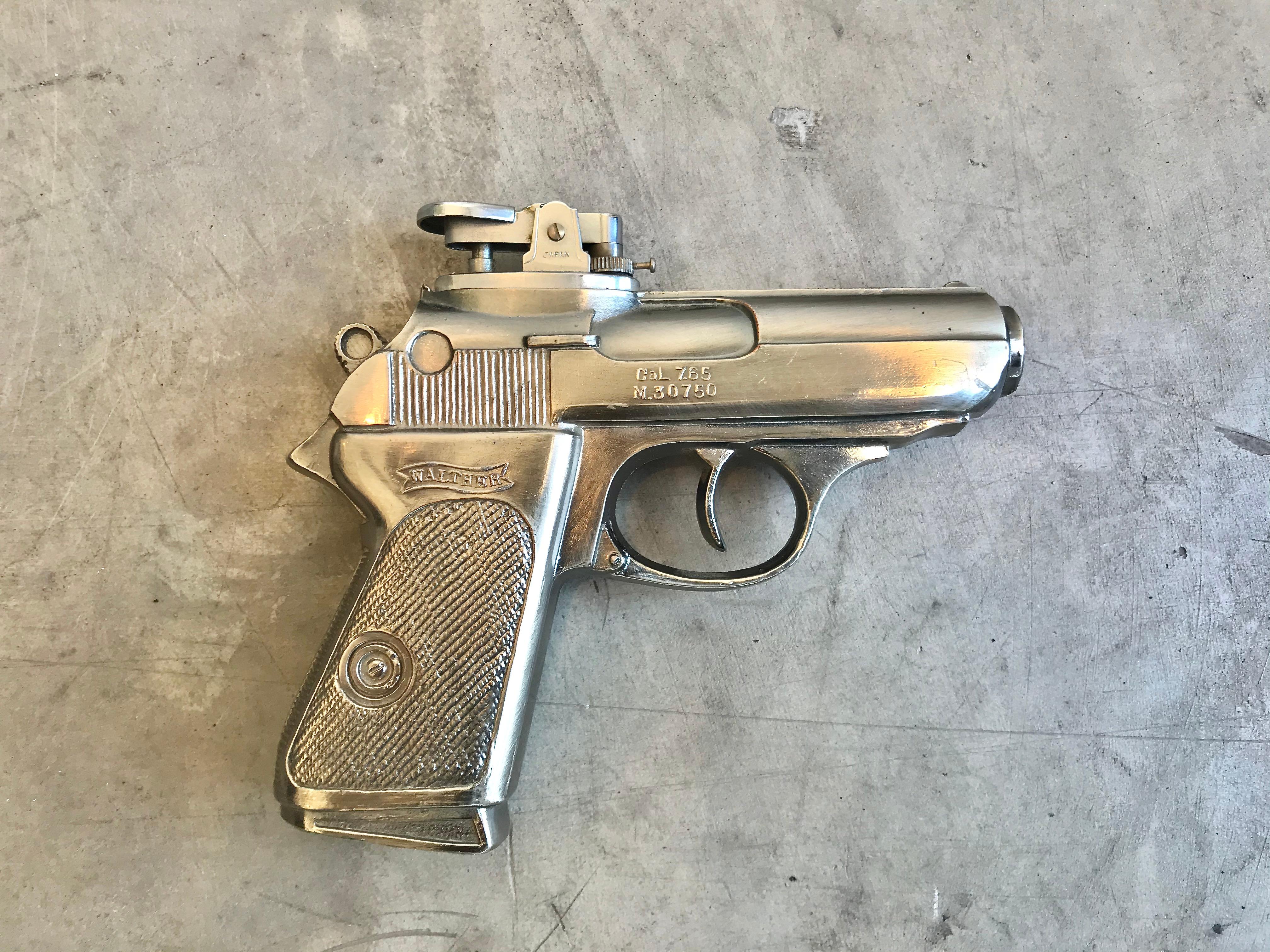 Cool vintage table lighter in the shape of a handgun. Handgun is a Walther-PPK model. Same gun used by James Bond. Made of metal. Made in Japan by Westland Co as seen on original sticker. Good working condition. Great object.

 