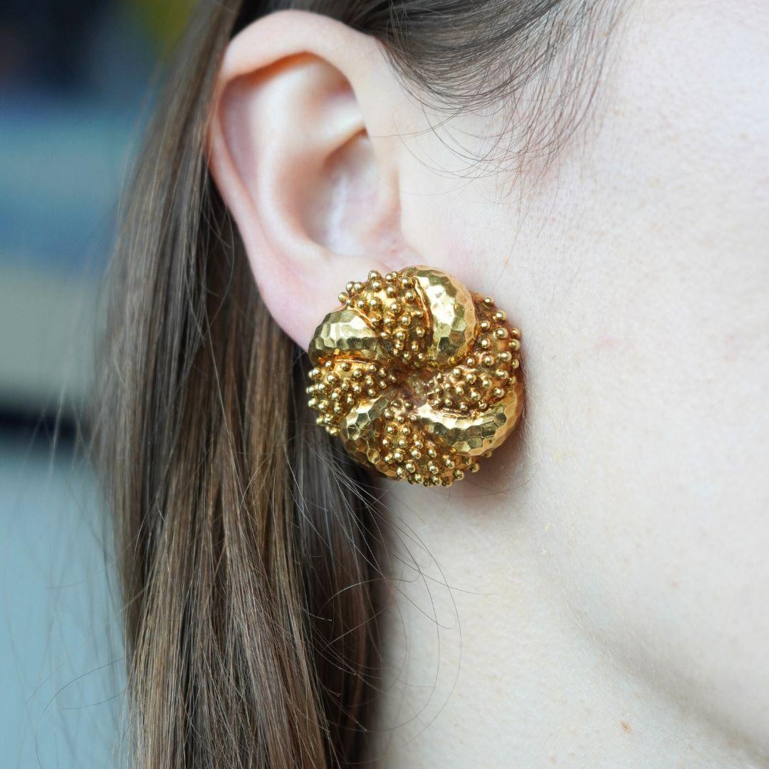 This pair of vintage 18k yellow gold earrings by Wander, formerly known as Wander & Fils, showcases the brand’s signature craftsmanship rooted in mid-century French design. Featuring a stylized floral motif, these circa 1960s- 1970s earrings are