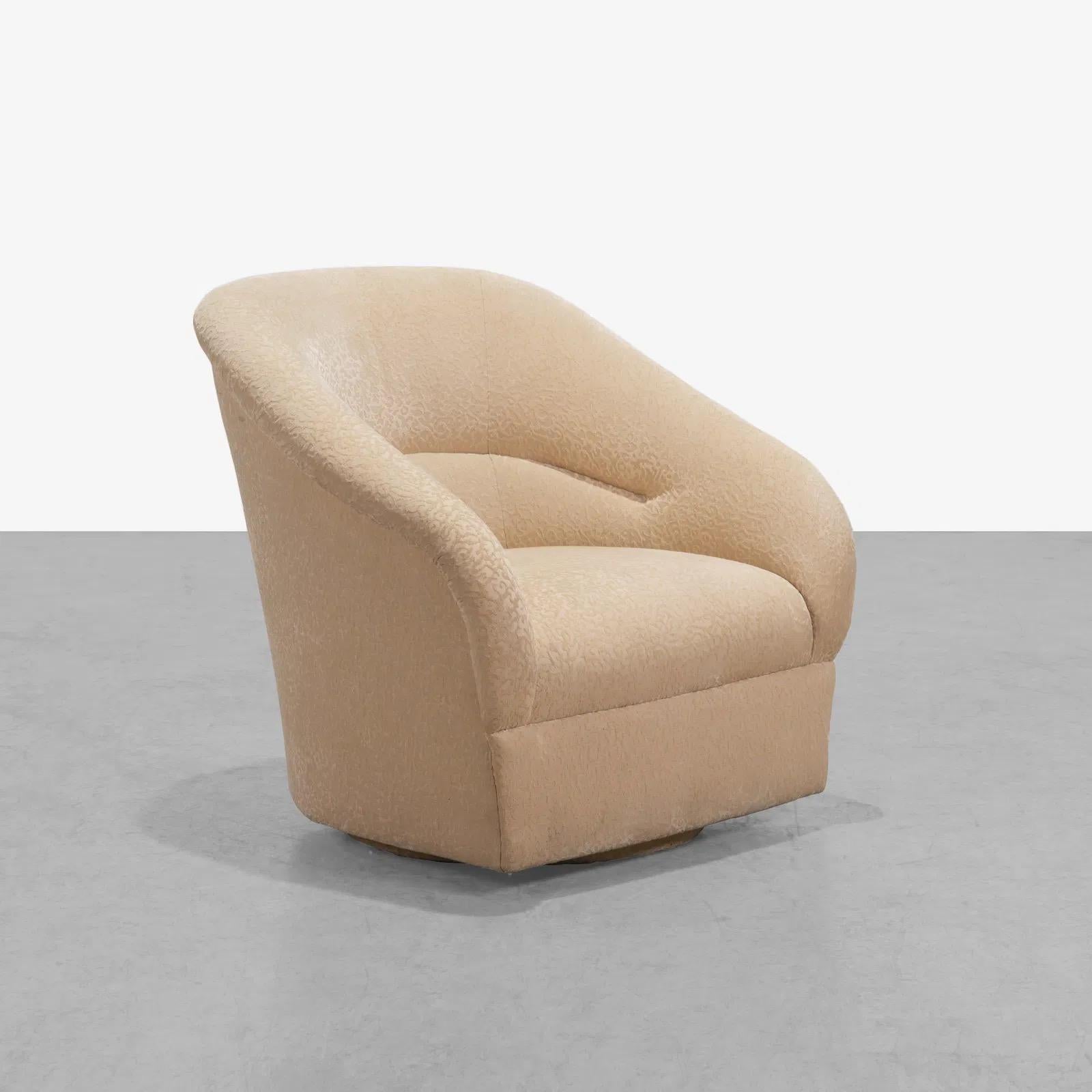 The Ward Bennett style club chair features a swivel base and gorgeous textured cream upholstery.