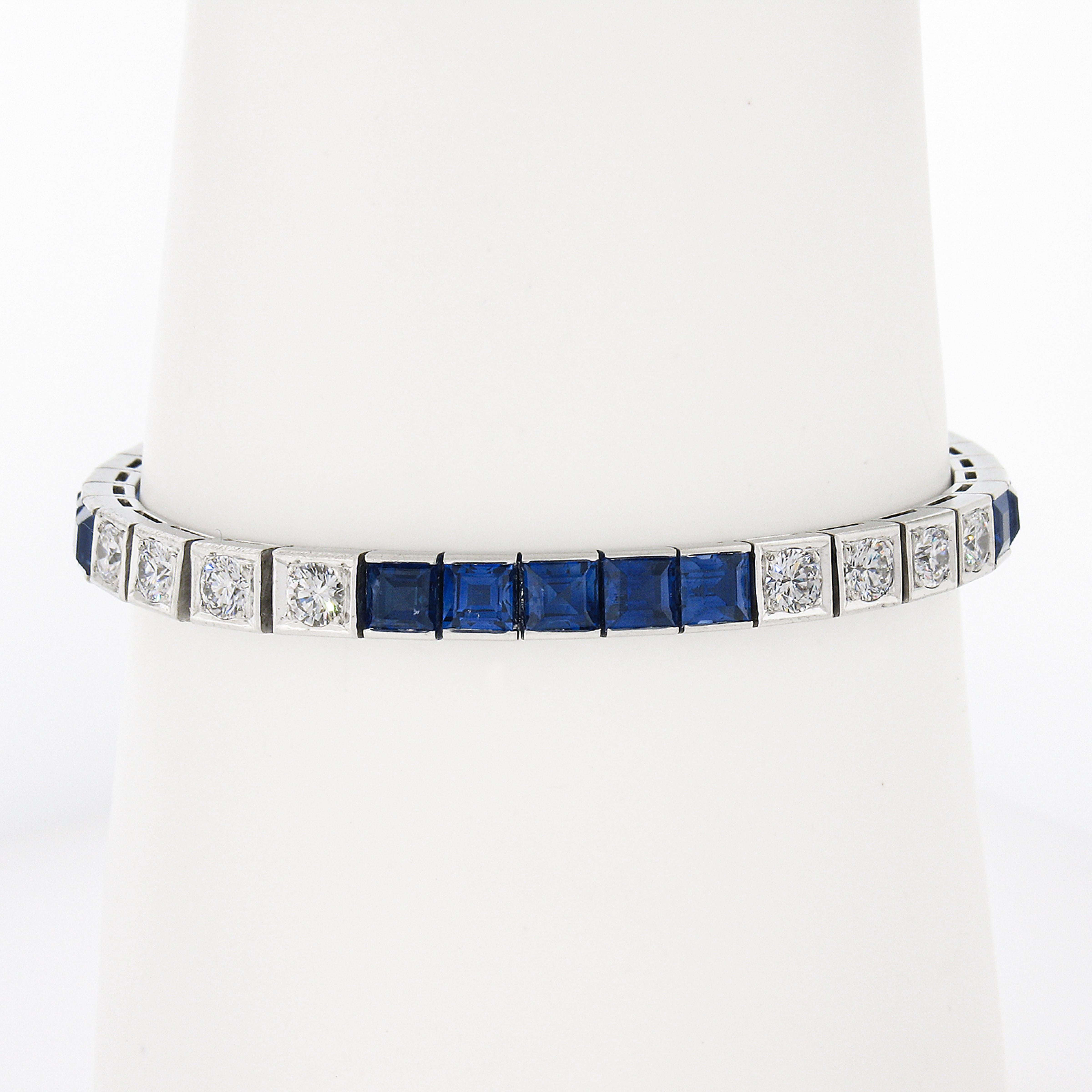 This magnificent vintage line tennis bracelet is crafted in solid platinum by Waslikoff & Son. It features very fine quality natural sapphire and diamond stones that are set in groups and alternate throughout the bracelet. These beautiful square