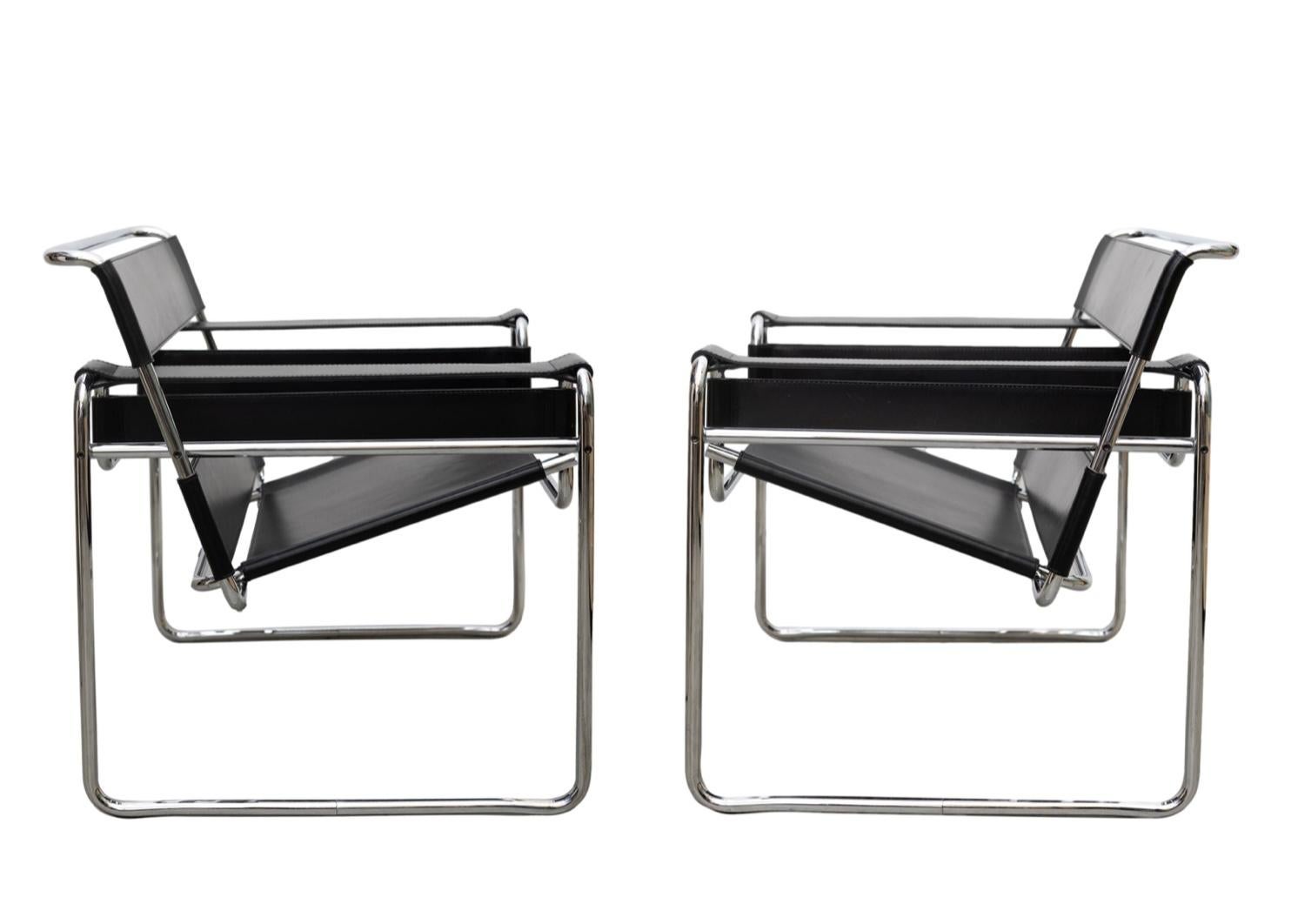 Pair of the iconic Mid-Century Modern Wassily chairs with chrome frames and black leather. In great vintage condition with some beautiful light wear to the leather.