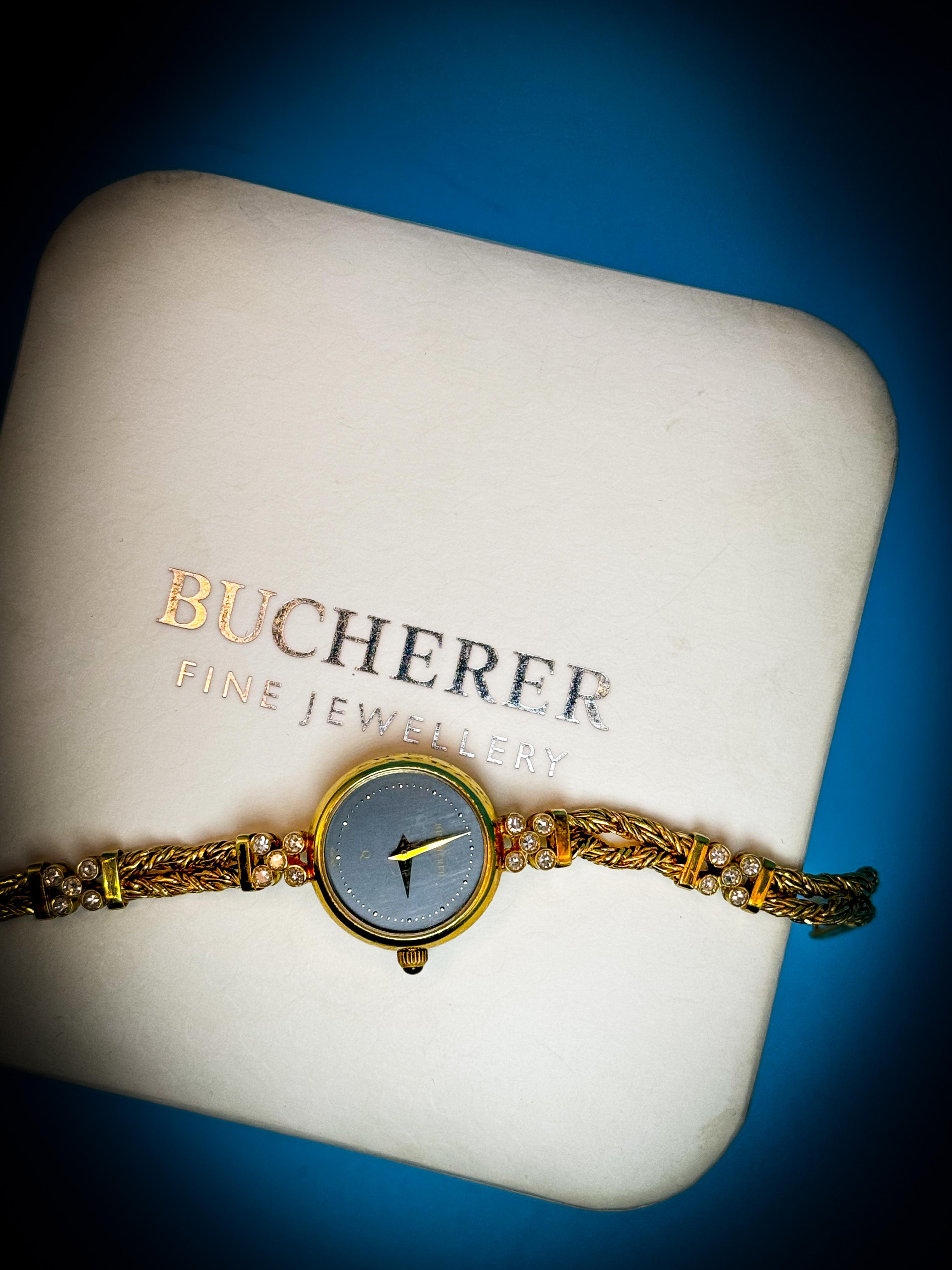 Step into a world of timeless luxury with this exquisite Vintage Bucherer Lady's Watch. Each glance at your wrist will remind you of the elegance of the past, blending seamlessly with the quality and style of the present.

Crafted from lustrous 18K