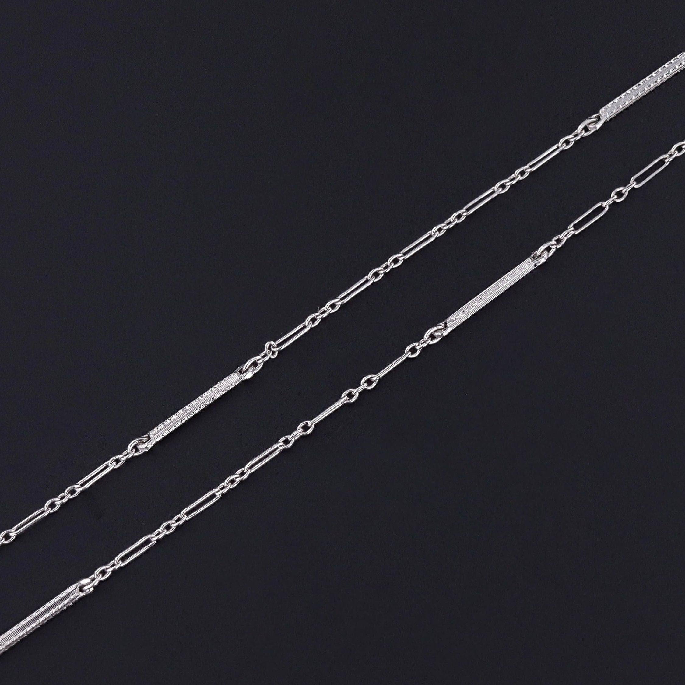 Vintage Watch Chain Necklace: Embrace the timeless elegance of the Roaring 1920s with this vintage 14k white gold watch chain necklace.

The chain measures 24 inches long with a 3.5 inch drop that ends with a spring ring. It weighs 3.76 grams and is