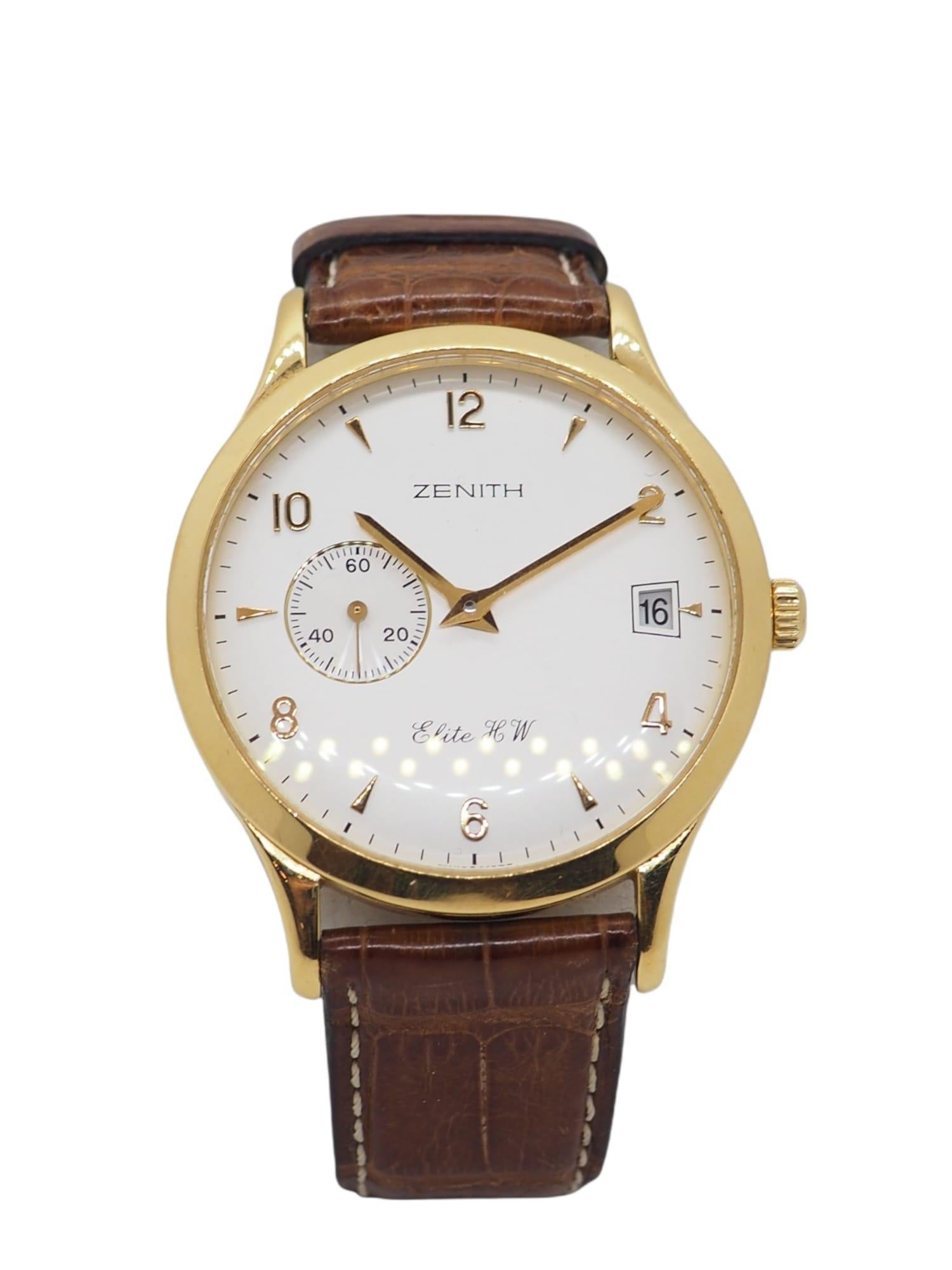 Indulge in the timeless allure of vintage luxury with our exquisite Zenith Elite HW timepiece. Crafted in 18K gold and adorned with a luxurious brown alligator strap, this watch exudes sophistication and refinement, making it a treasured addition to