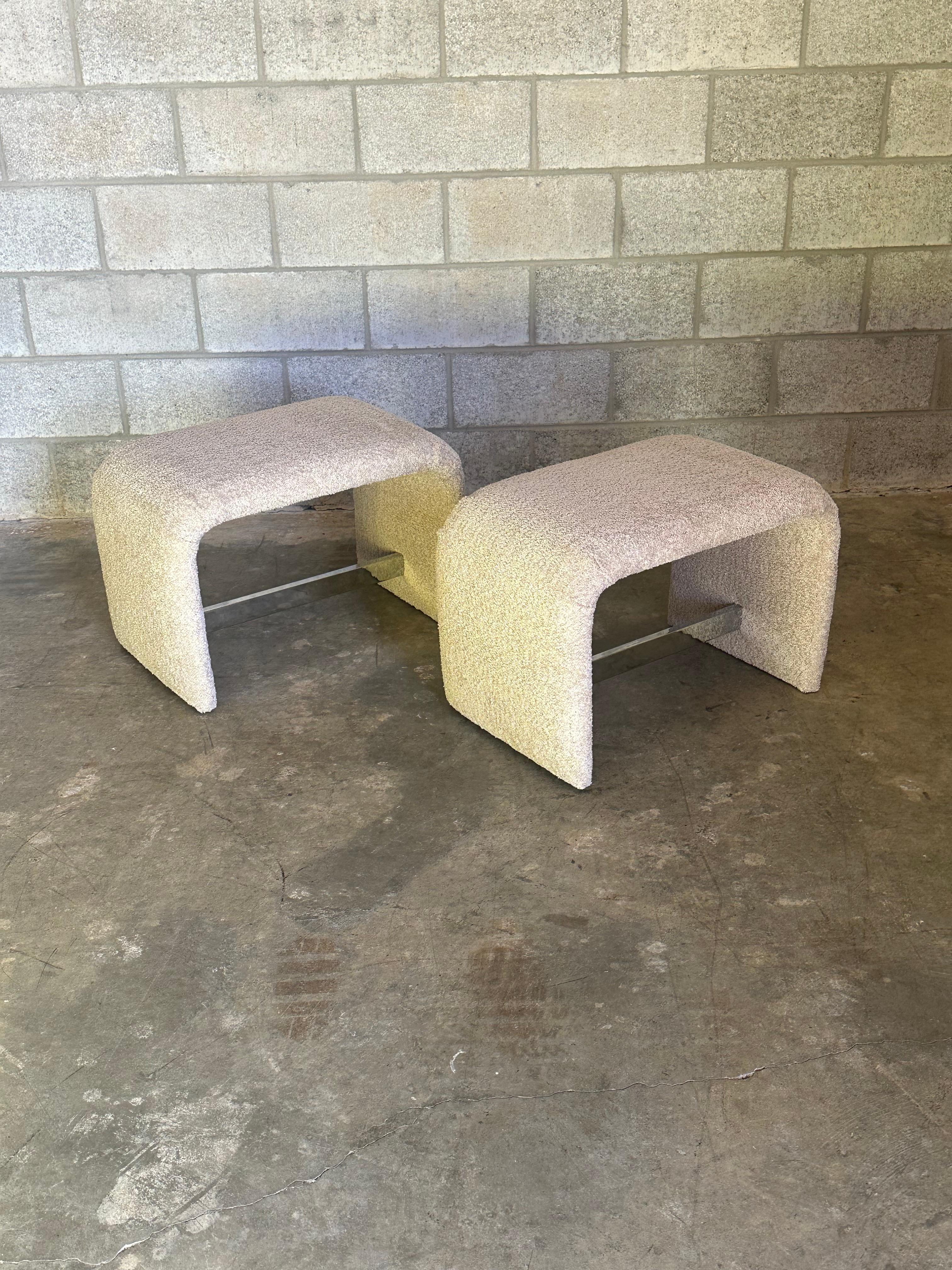 Pair of upholstered waterfall ottomans/ stools/ petite benches by Thayer Coggin and likely designed by Milo Baughman. What makes these unique is the chrome stretcher which runs underneath.

Use as ottomans or footstools. Great supplemental seating. 
