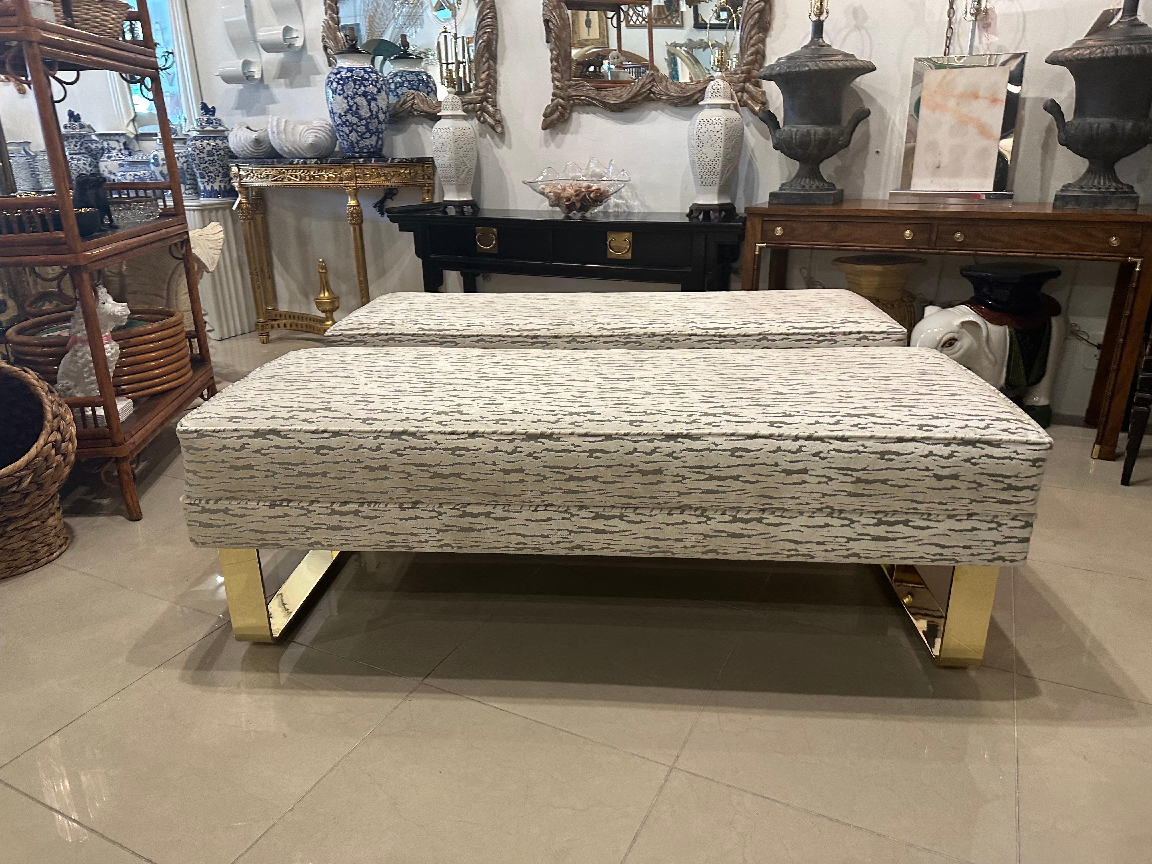 The most amazing brass bench, two available at time of listing. These are being sold individually. The brass waterfall legs are solid brass and heavy! They have been polished. Newly upholstered in a cut velvet faux bois fabric. These are from an