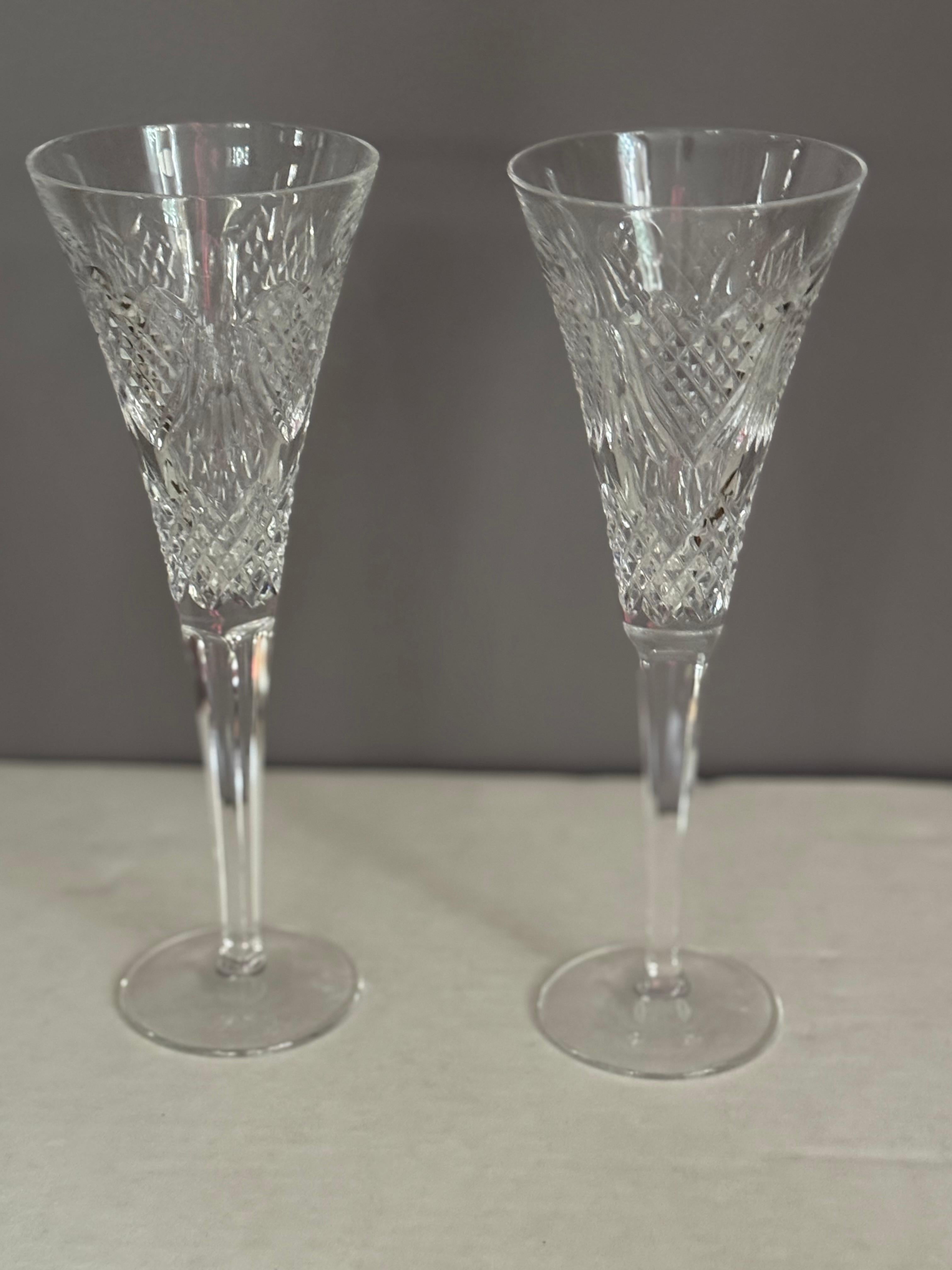 Stunning, preowned like new Champagne Flute in the love celebration  pattern  by the Waterford Crystal Company.  It is 10 1/4
