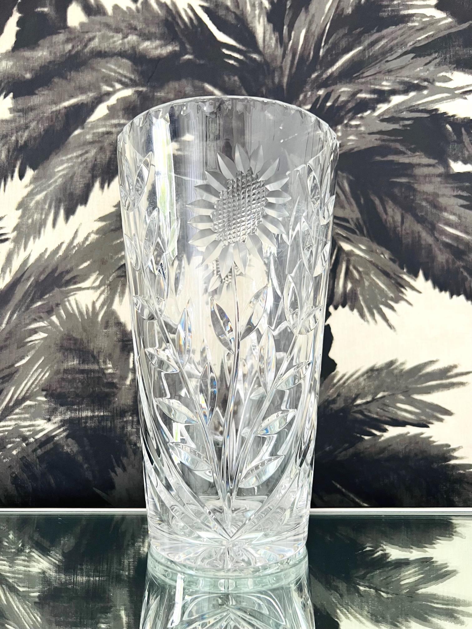 Large vintage Waterford Crystal vase with geometric cut glass designs and etched sunflower motifs reminiscent of the Art Deco era. The vase is heavy set in weight and features a unique chain beveled rim and starburst etchings on the underside.