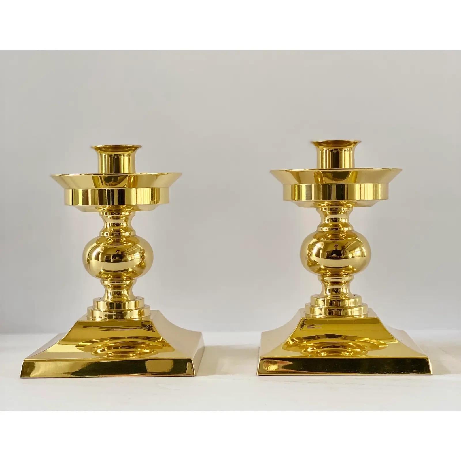 We are very pleased to offer an elegant pair of candle holders by Waterford, circa late 20th Century. The Lismore design is one of Waterford’s oldest and most unique designs. This stunning pair showcases a brass square base with a crystal hurricane