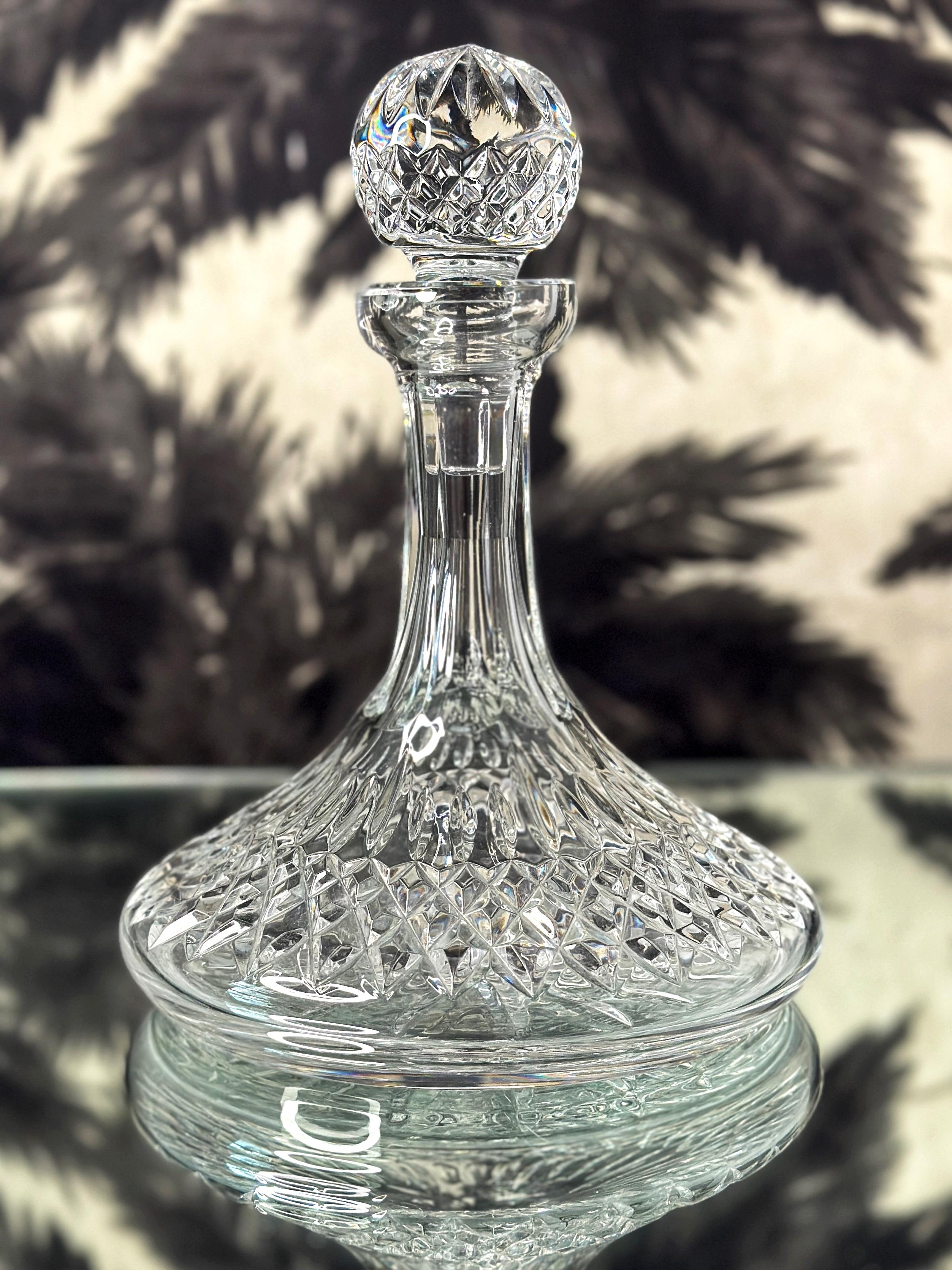 Stunning vintage ships decanters by Waterford Crystal from the classic Lismore Series, first introduced in the early 1950's. Handcrafted and mouth-blown lead crystal featuring brilliant prismatic diamond cuts with etched designs throughout. Also