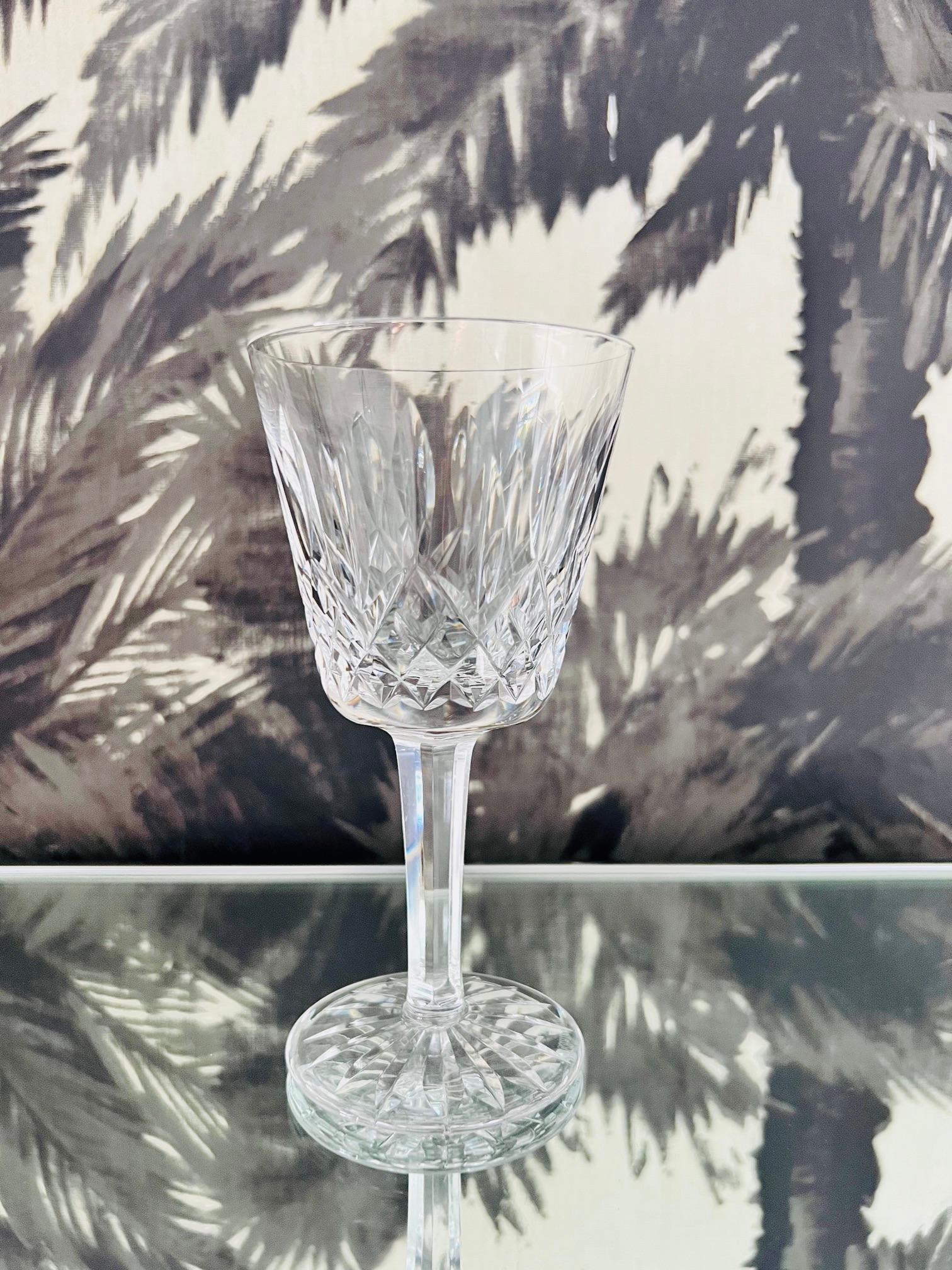 Single luxe crystal wine glass from Waterford Crystal. The Lismore Collection is perhaps Waterford's most distinguished design featuring hand blown crystal with the pattern's signature diamond and wedge cuts. First introduced in the early 1950s, the