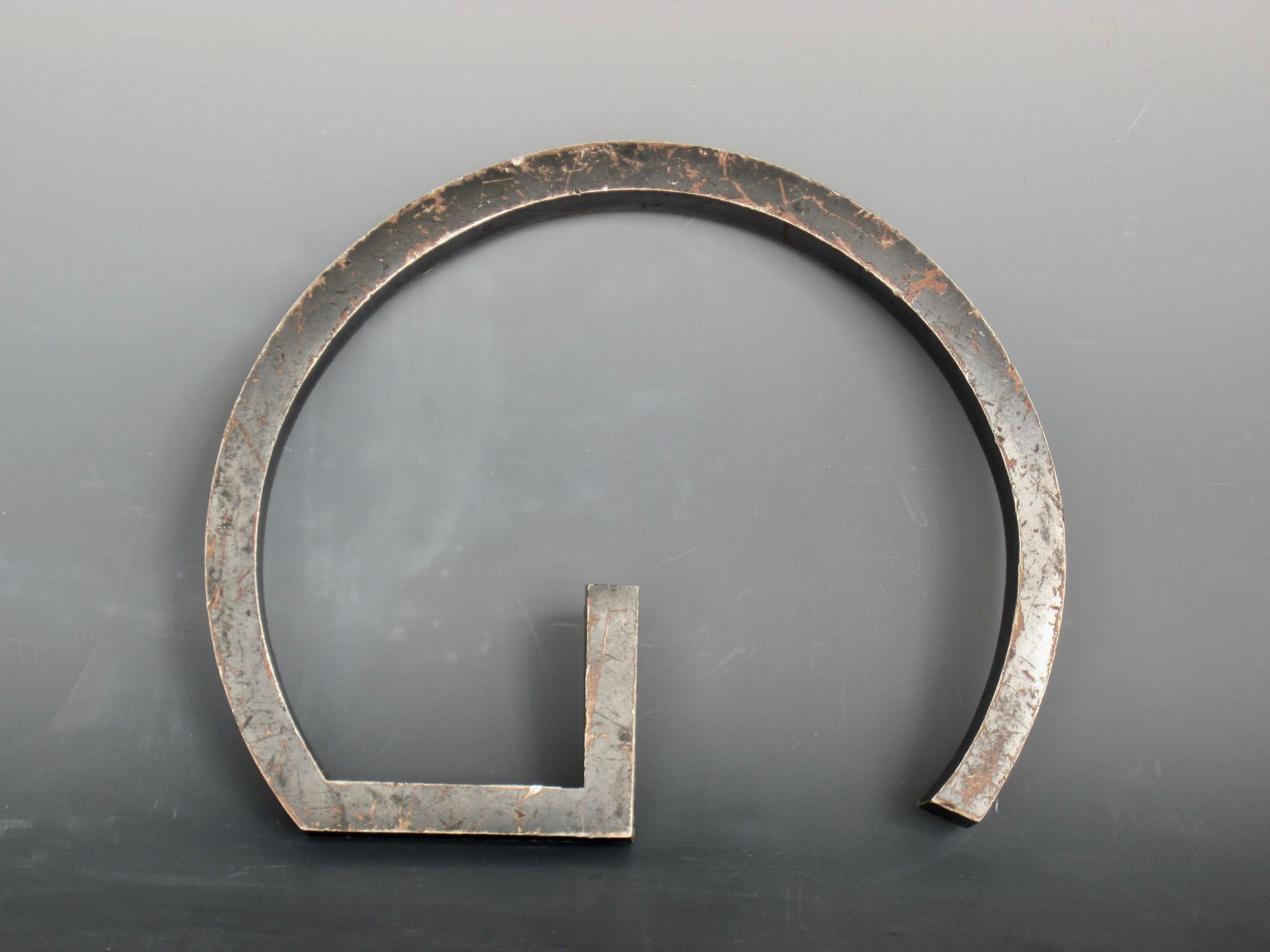 Weathered black solid metal letter G emblem. Four screw holes on reverse for mounting. A lot of character from the patina and scratches showing it's usage over time.