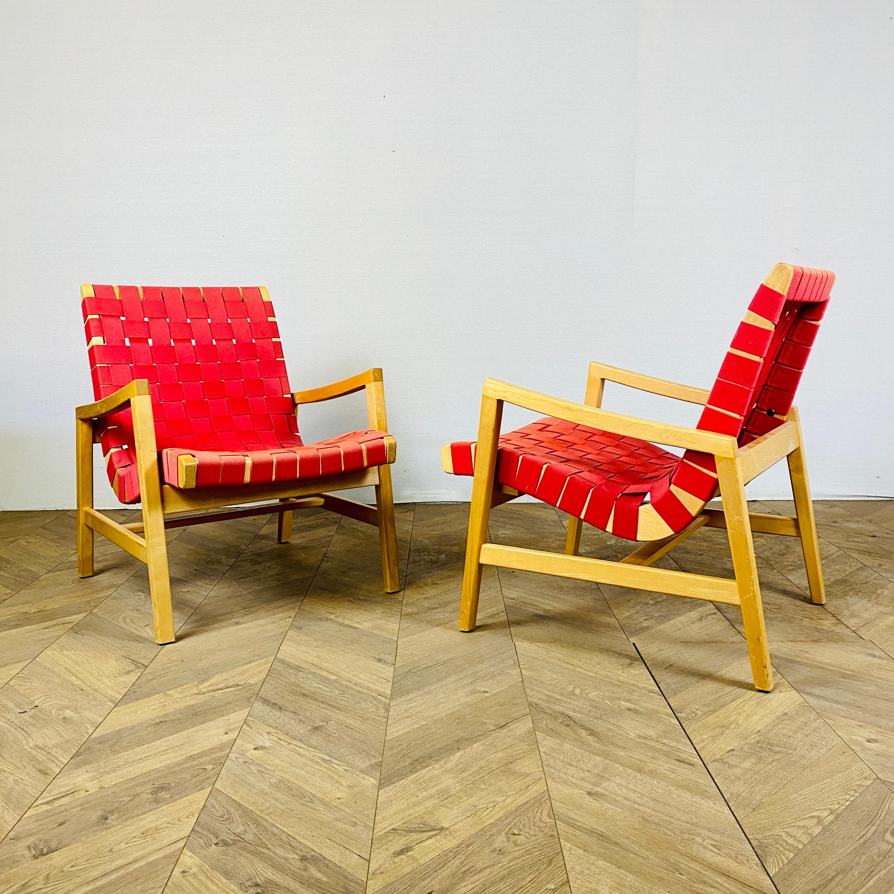 A Pair of Super Stylish armchairs Designed by Jens Risom in 1941 for Knoll.

Boasting clean lines and crafted from high quality maple with strap work / webbed seating, the chairs are super comfortable with great proportions.

In good vintage