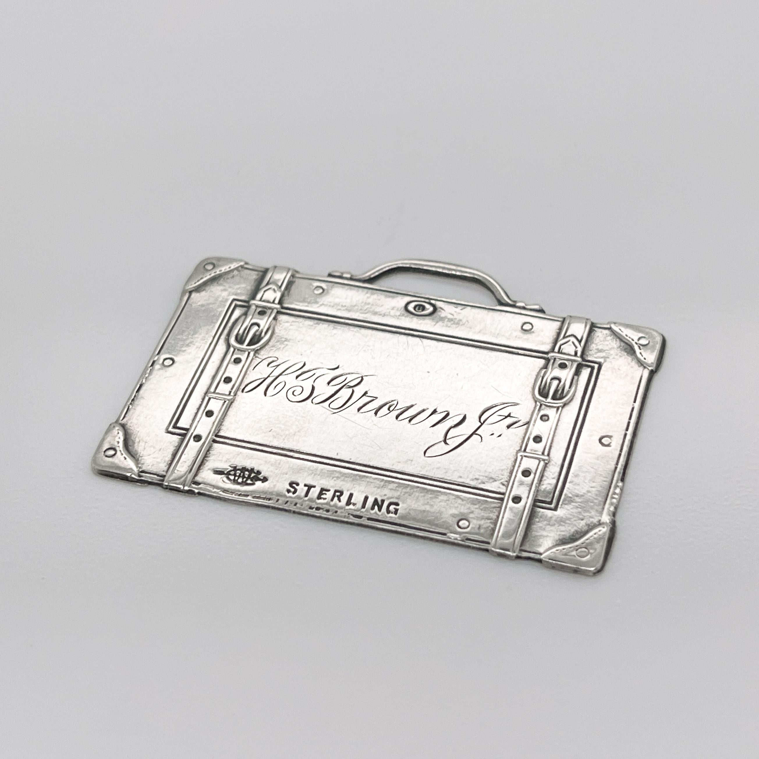 A fine vintage suitcase shaped luggage tag.

In sterling silver with raised buckles and corners to the case.

Made by the Webster Silver Co. 

Simply a terrific piece!

Date:
Early 20th Century

Overall Condition:
It is in overall good, as-pictured,