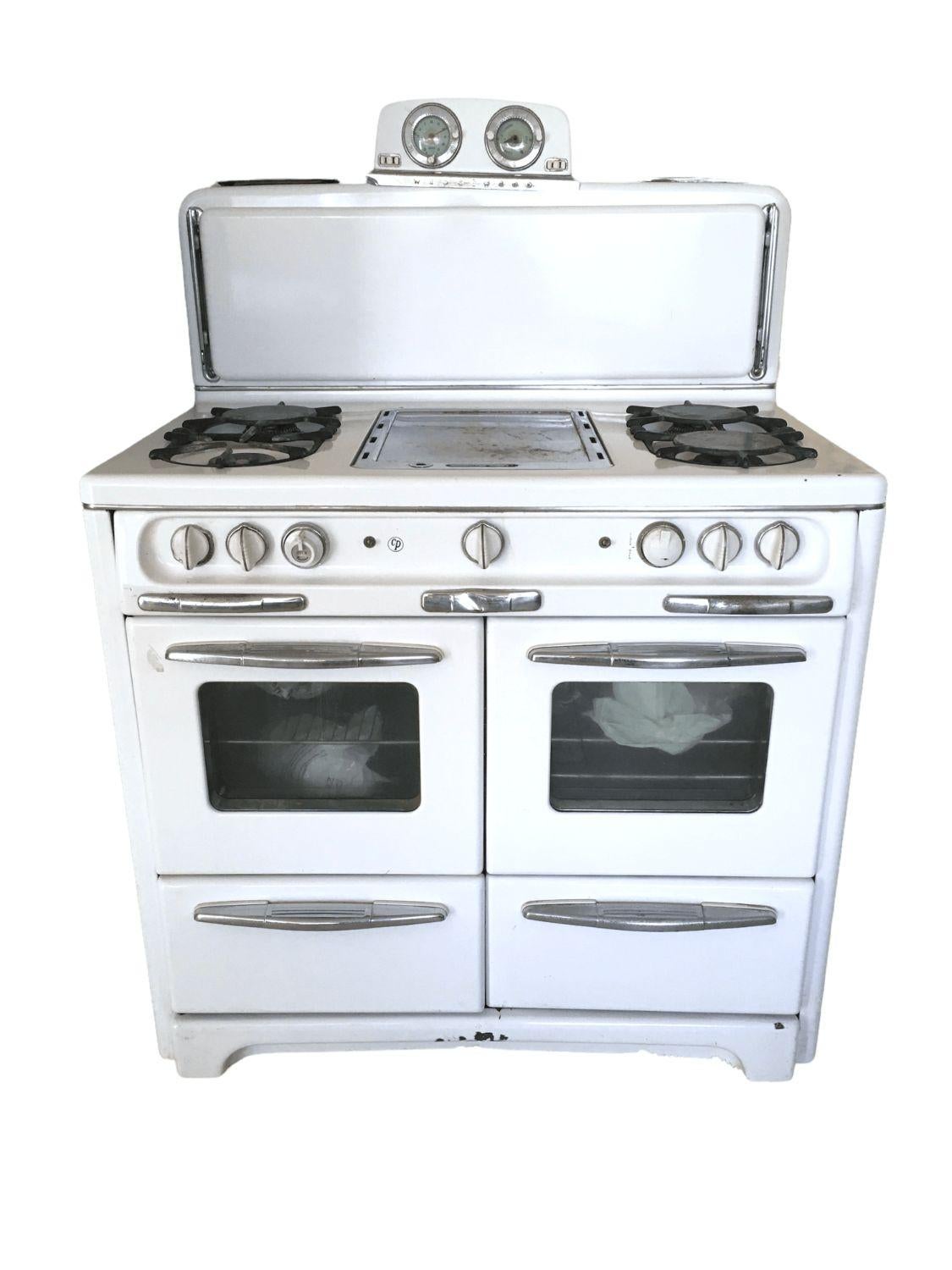 Vintage Wedgewood double oven stove in white. $2,200
 
This vintage stove features two ovens with windows in the doors, two Broilers, 4 Burners, Griddle, Bullet Light (tucked under the shelf), with Hinged Folding Shelf that keeps plates warm while